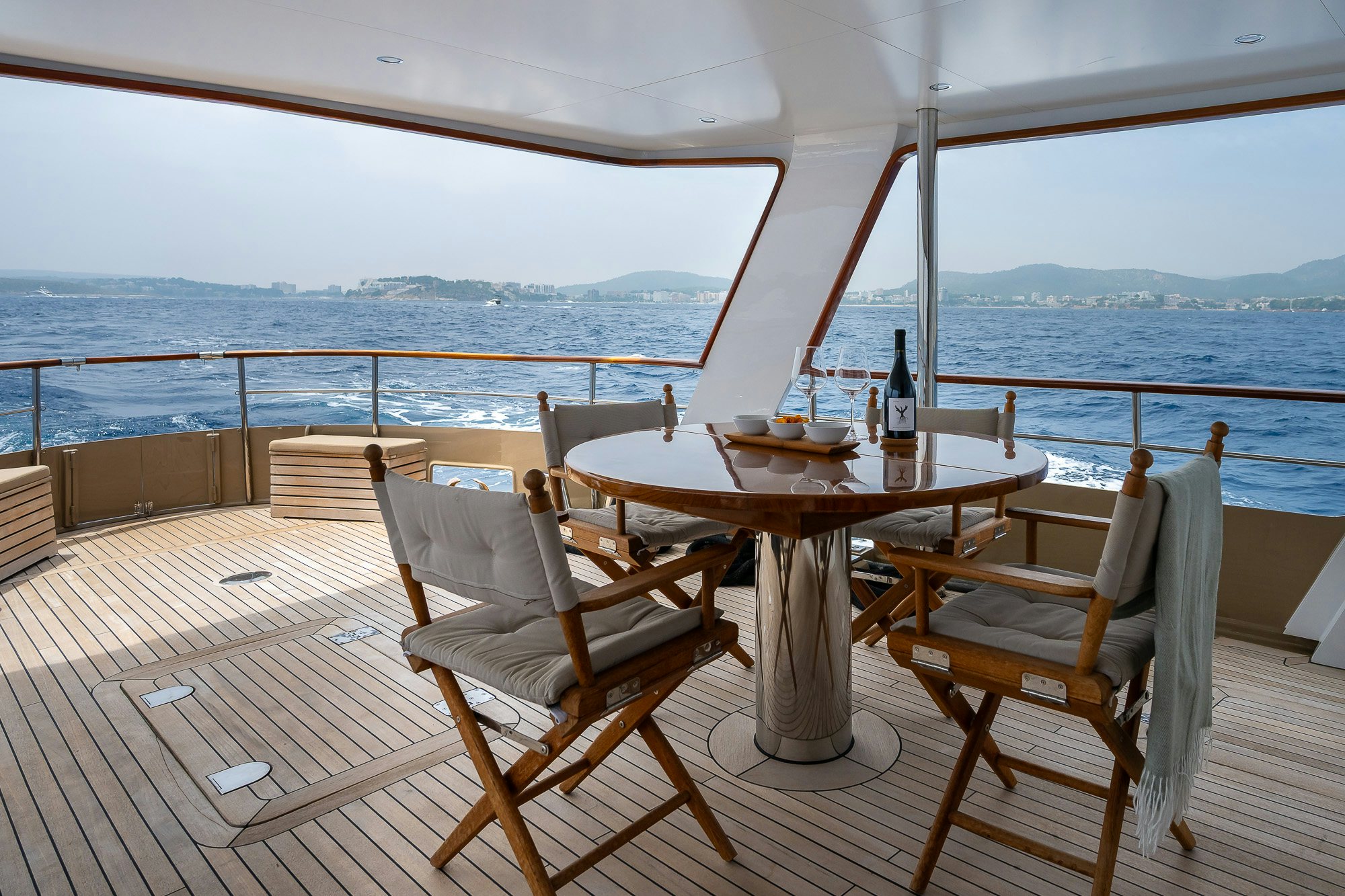 a table and chairs on a deck aboard BLACK PEPPER Yacht for Sale