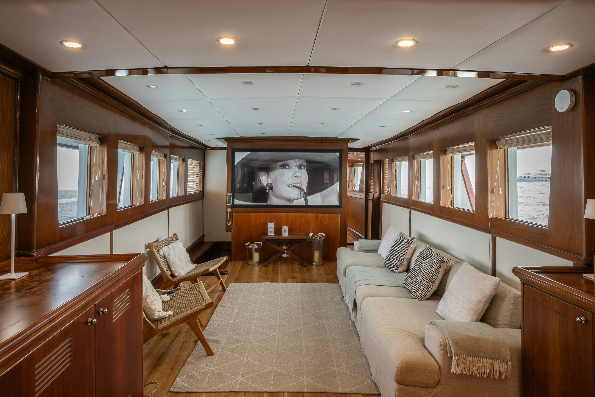 a living room with a wood cabinet aboard BLACK PEPPER Yacht for Sale