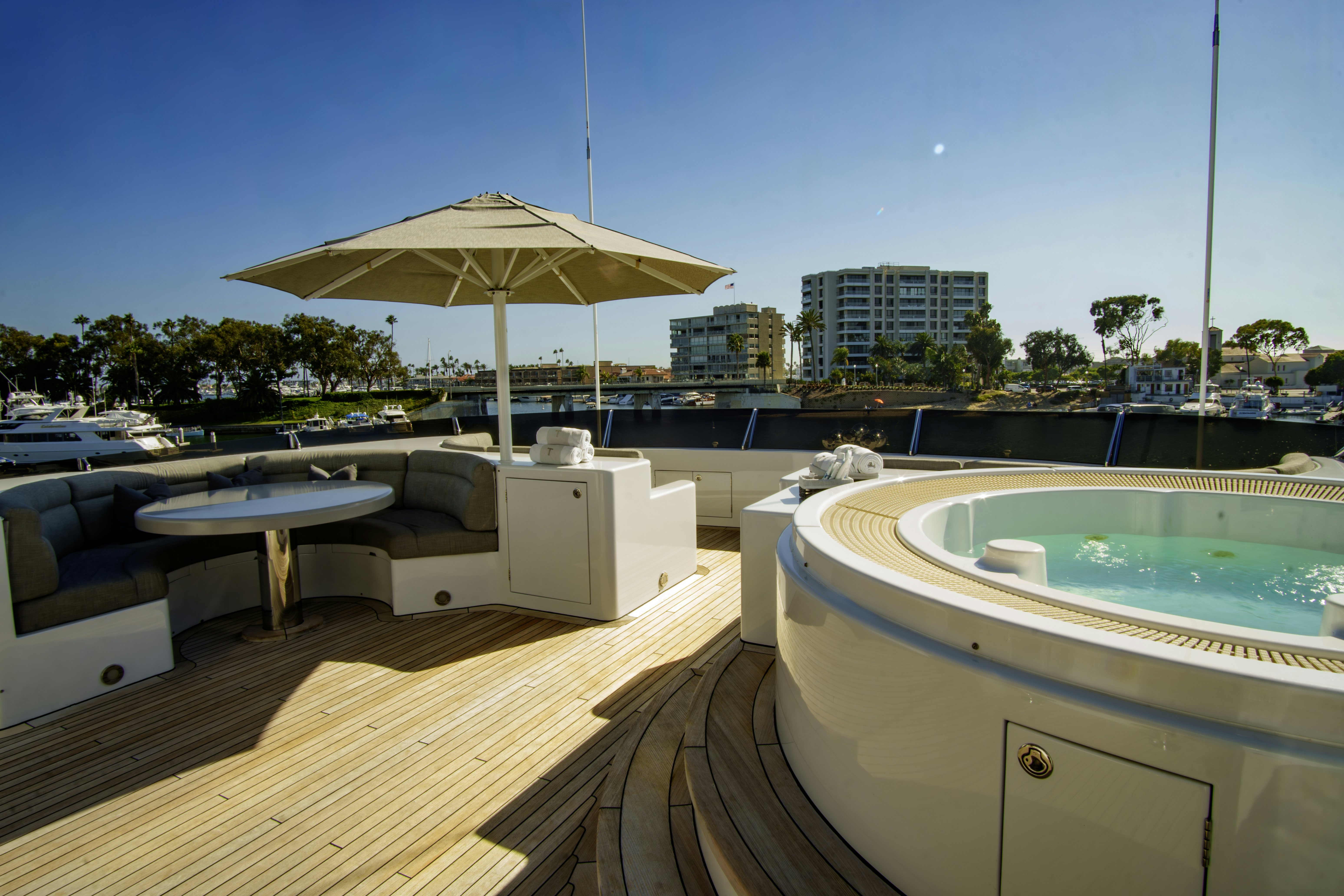 a pool with a table and umbrella aboard TRITON Yacht for Charter