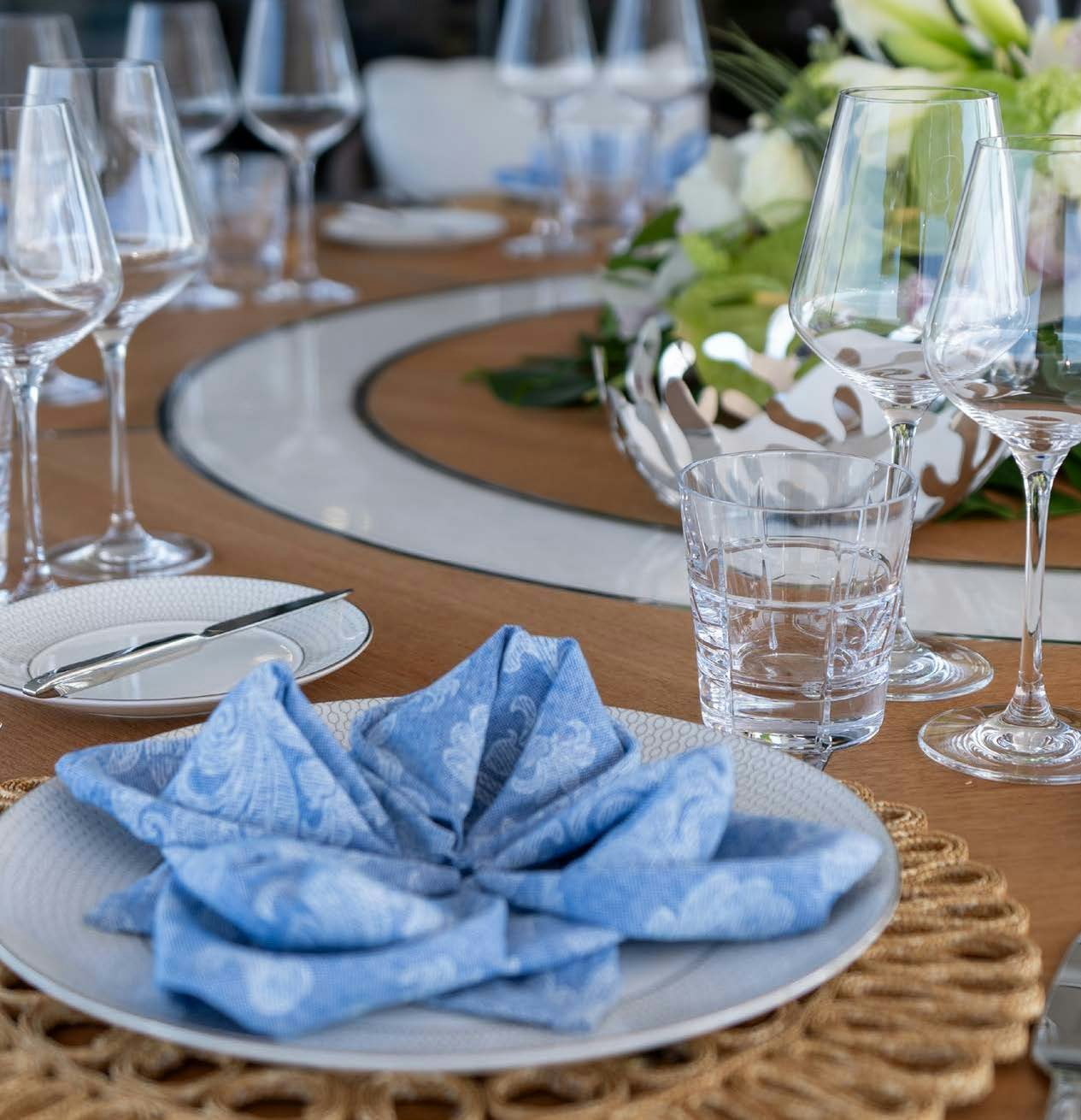 a table with glasses and plates aboard CHARADE Yacht for Charter