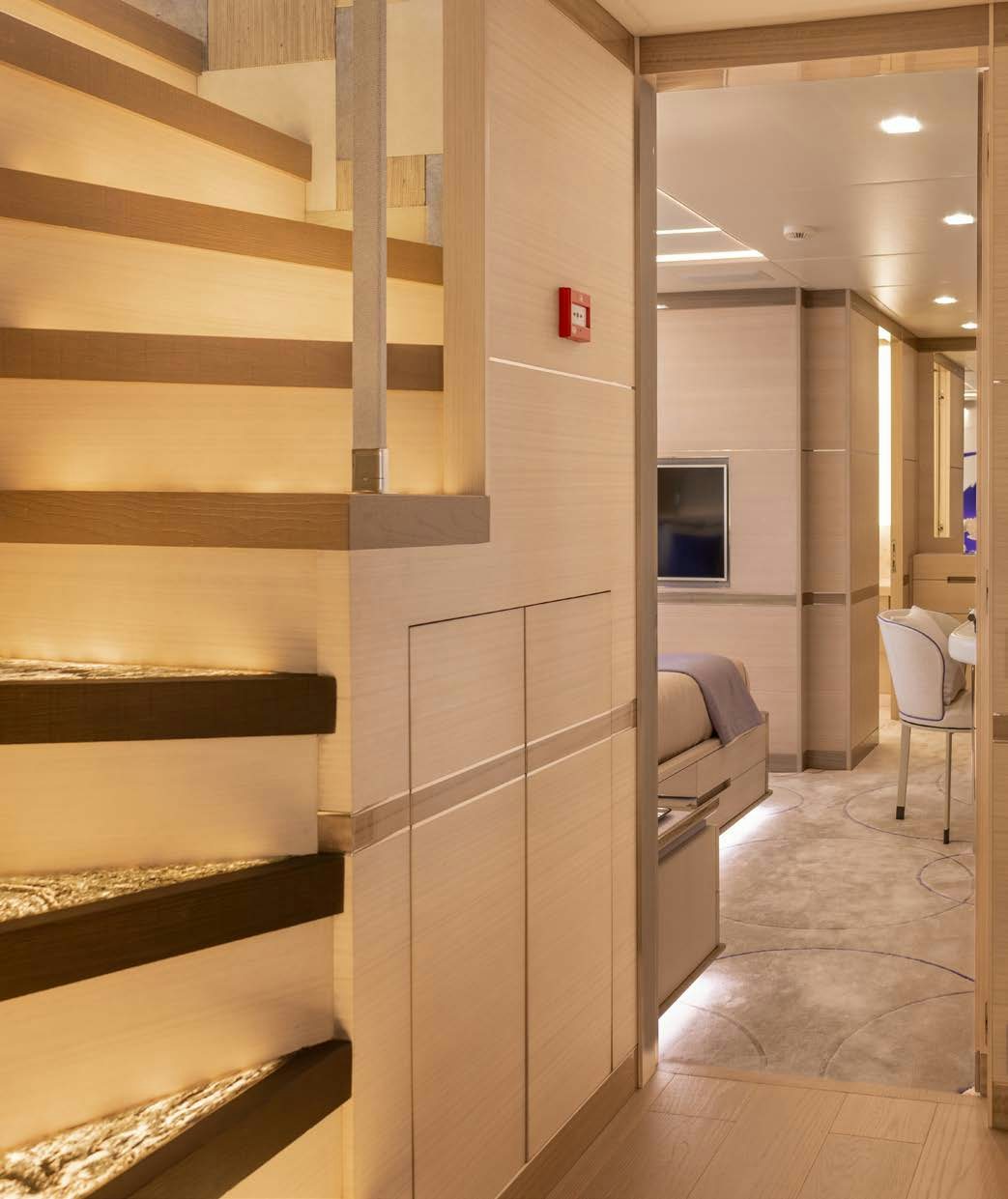a hallway with a large wood staircase aboard CHARADE Yacht for Charter
