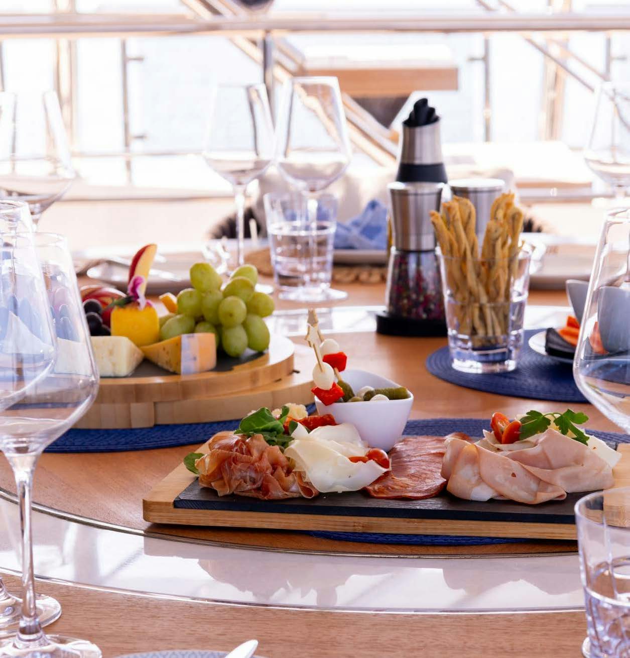 a table with food and glasses aboard CHARADE Yacht for Charter