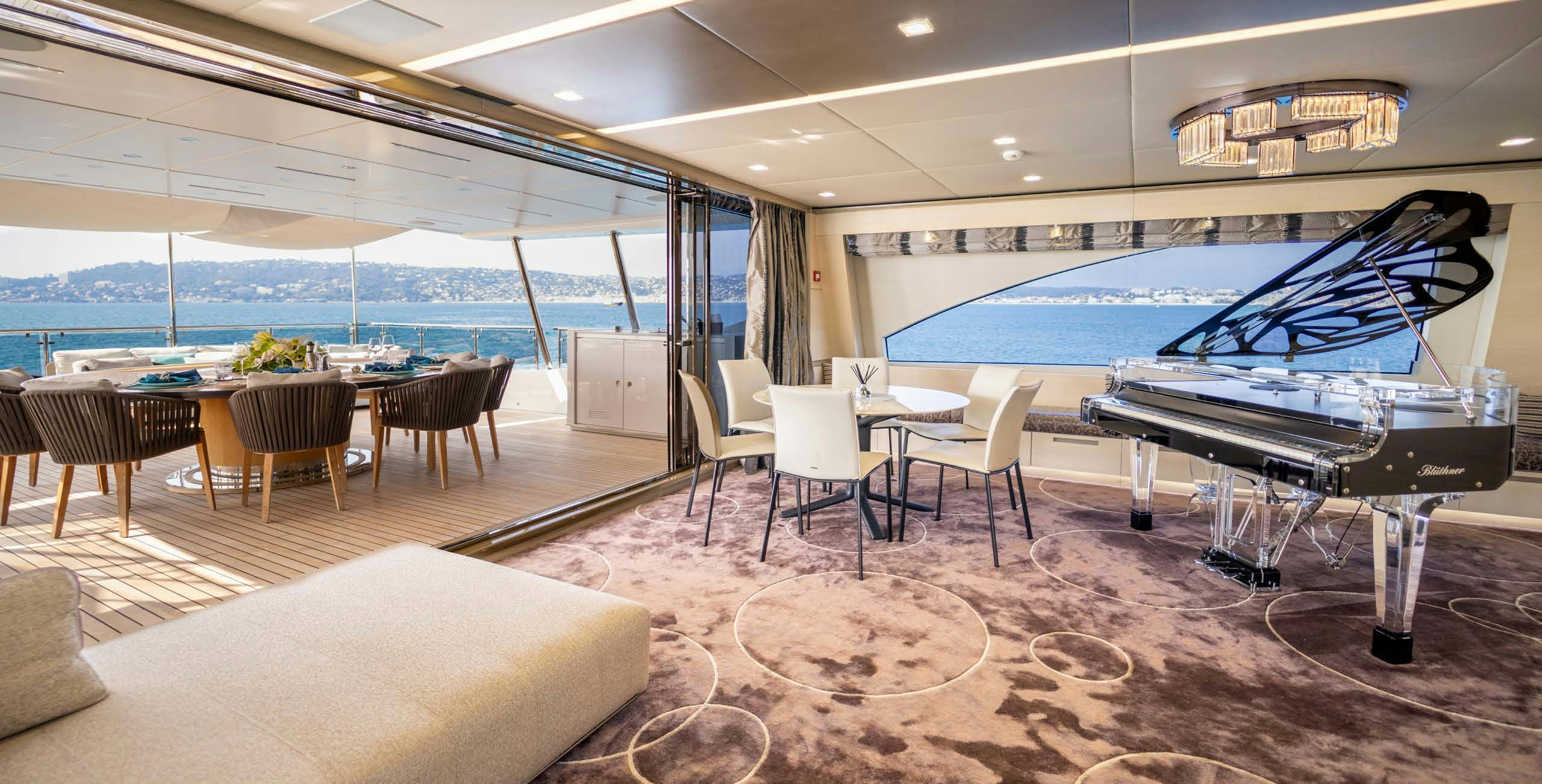 a room with a piano and chairs aboard CHARADE Yacht for Charter