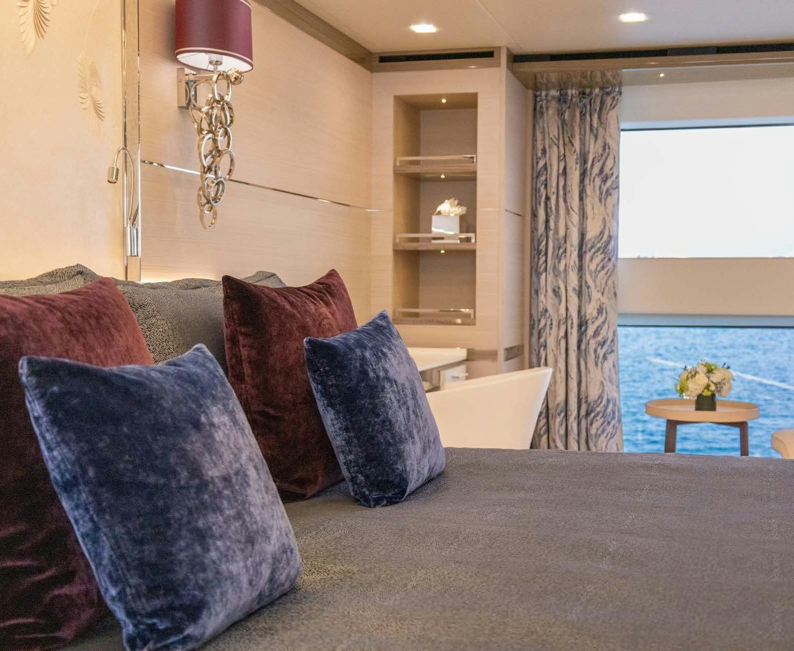 a couch with pillows and a table aboard CHARADE Yacht for Charter