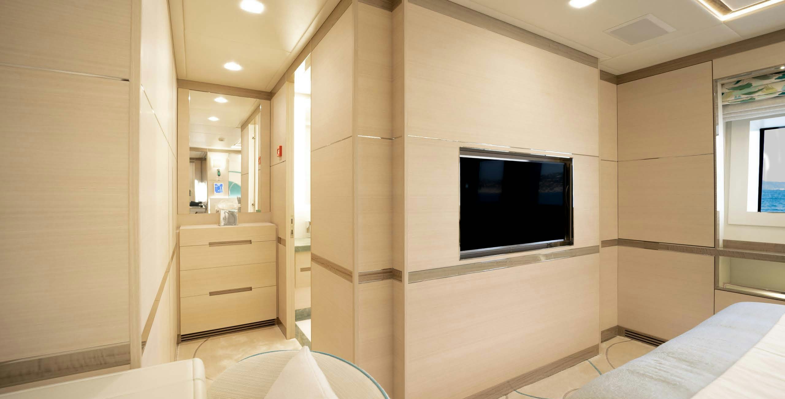 a room with a tv and a bed aboard CHARADE Yacht for Charter