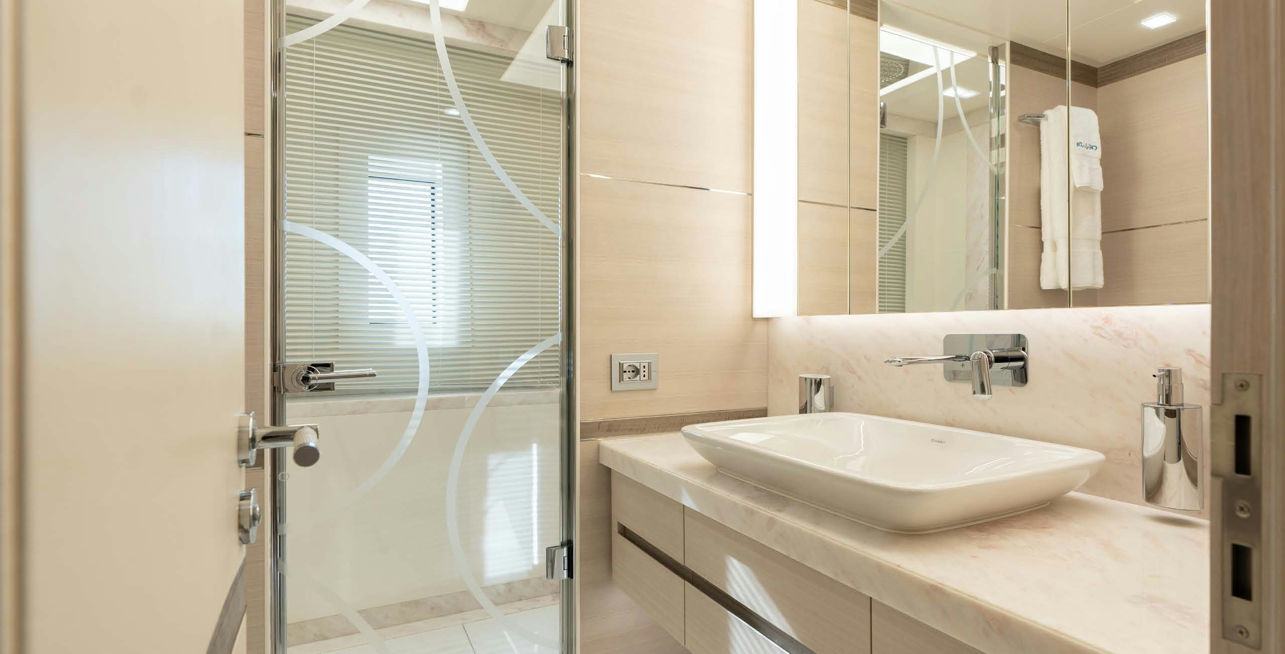 a bathroom with a sink and a mirror aboard CHARADE Yacht for Charter