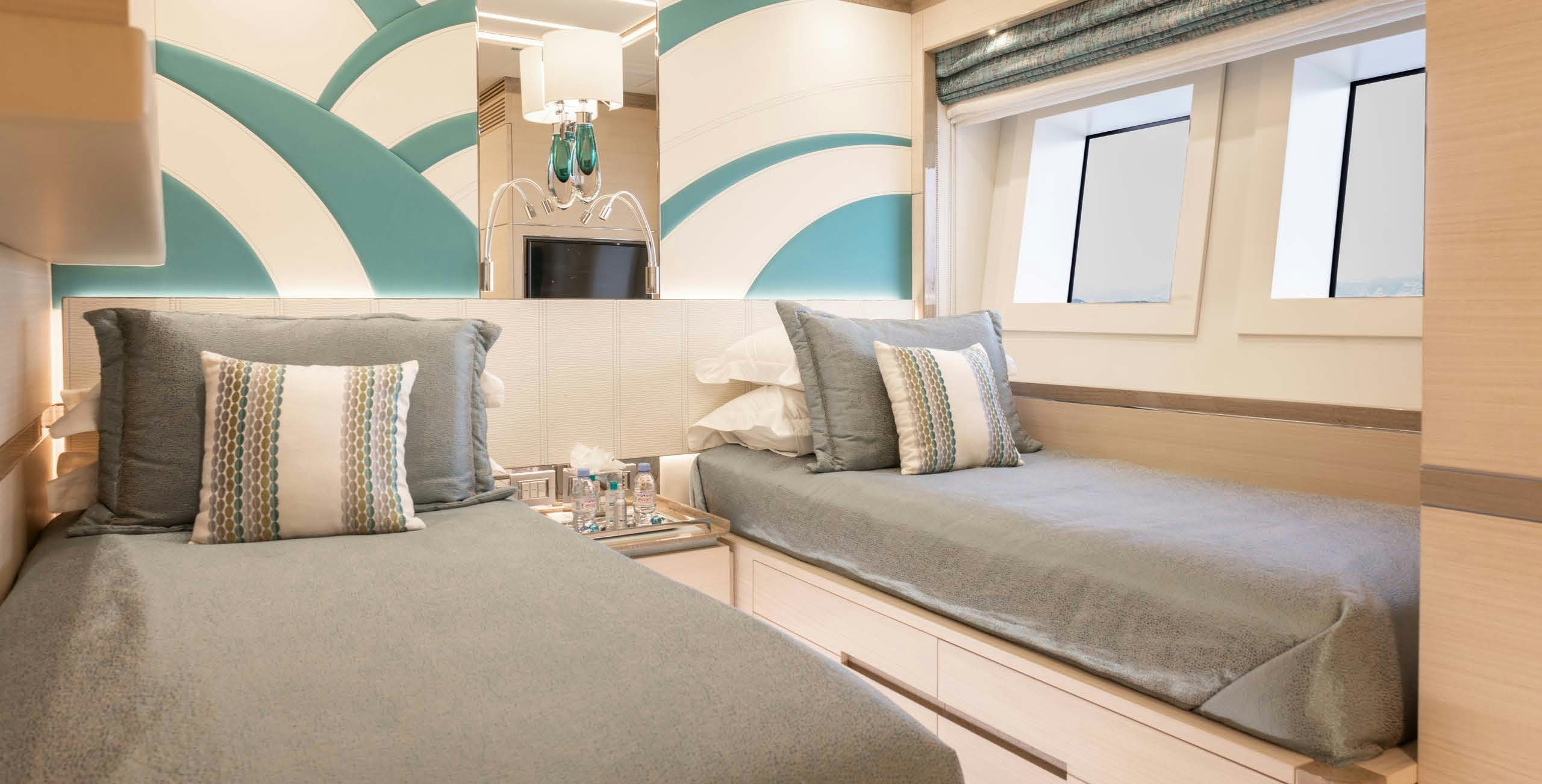 a room with a bed and a table aboard CHARADE Yacht for Charter