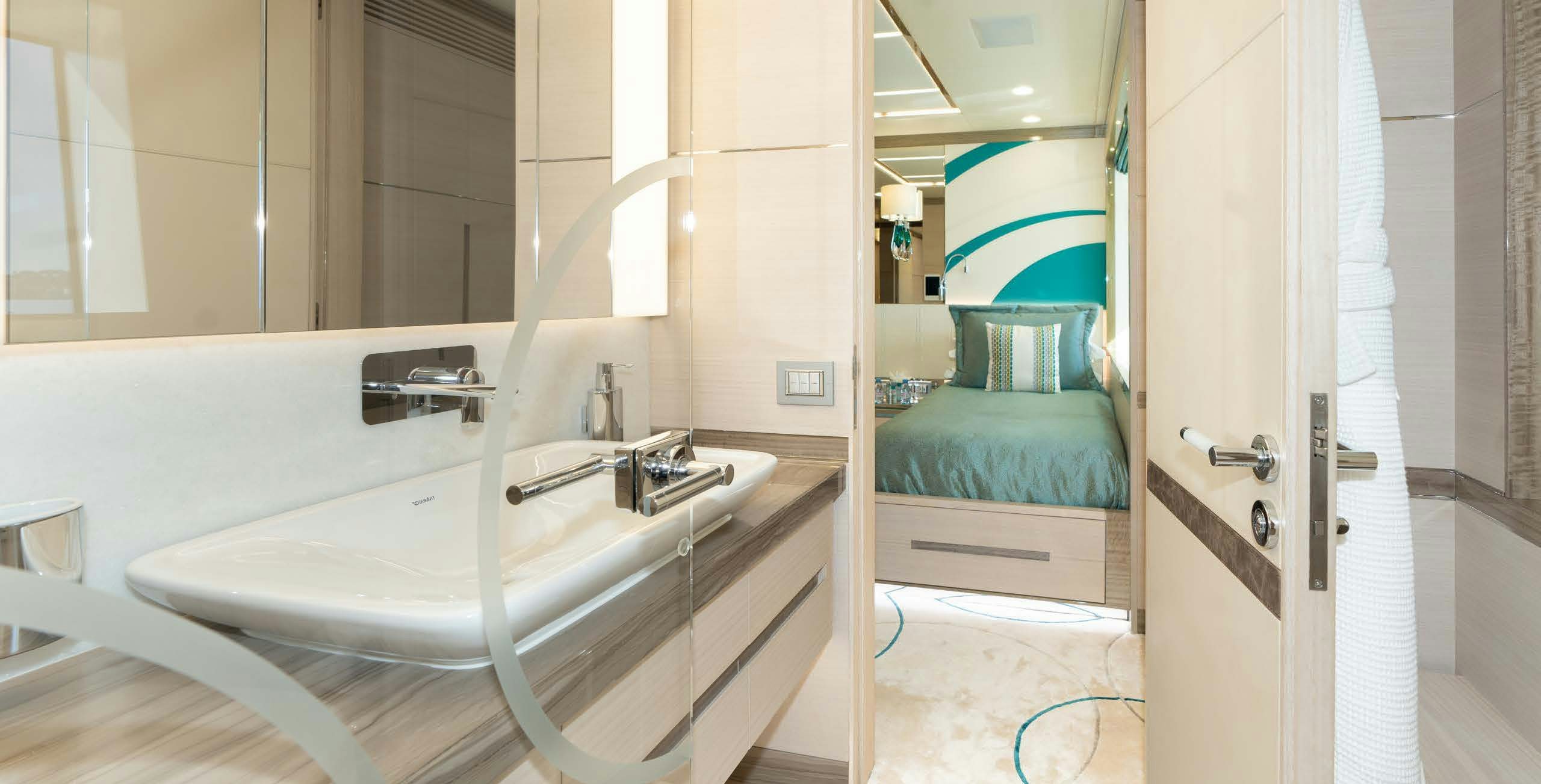 a bathroom with a sink and a bed aboard CHARADE Yacht for Charter