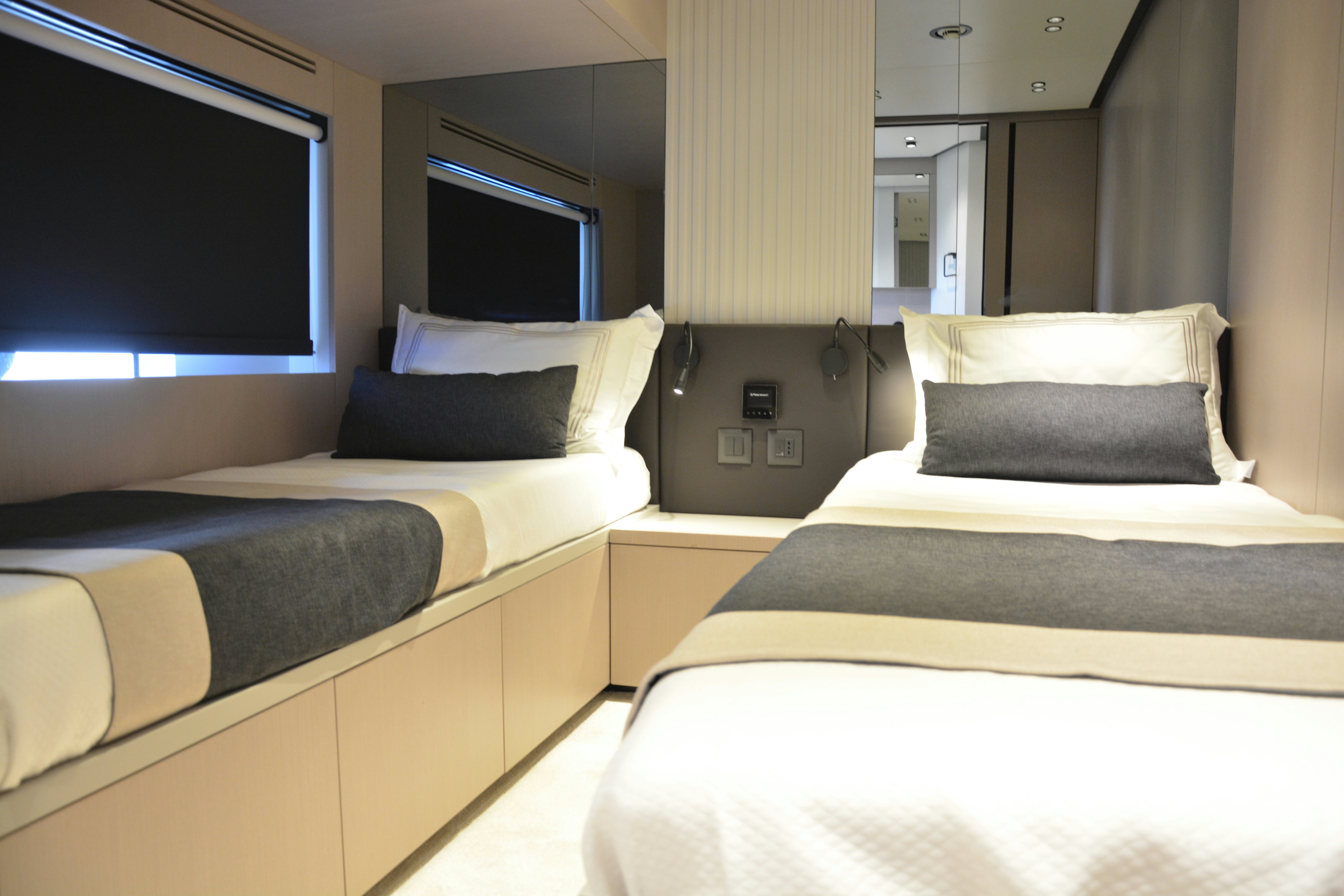 a room with beds and a television aboard ZIMA Yacht for Sale