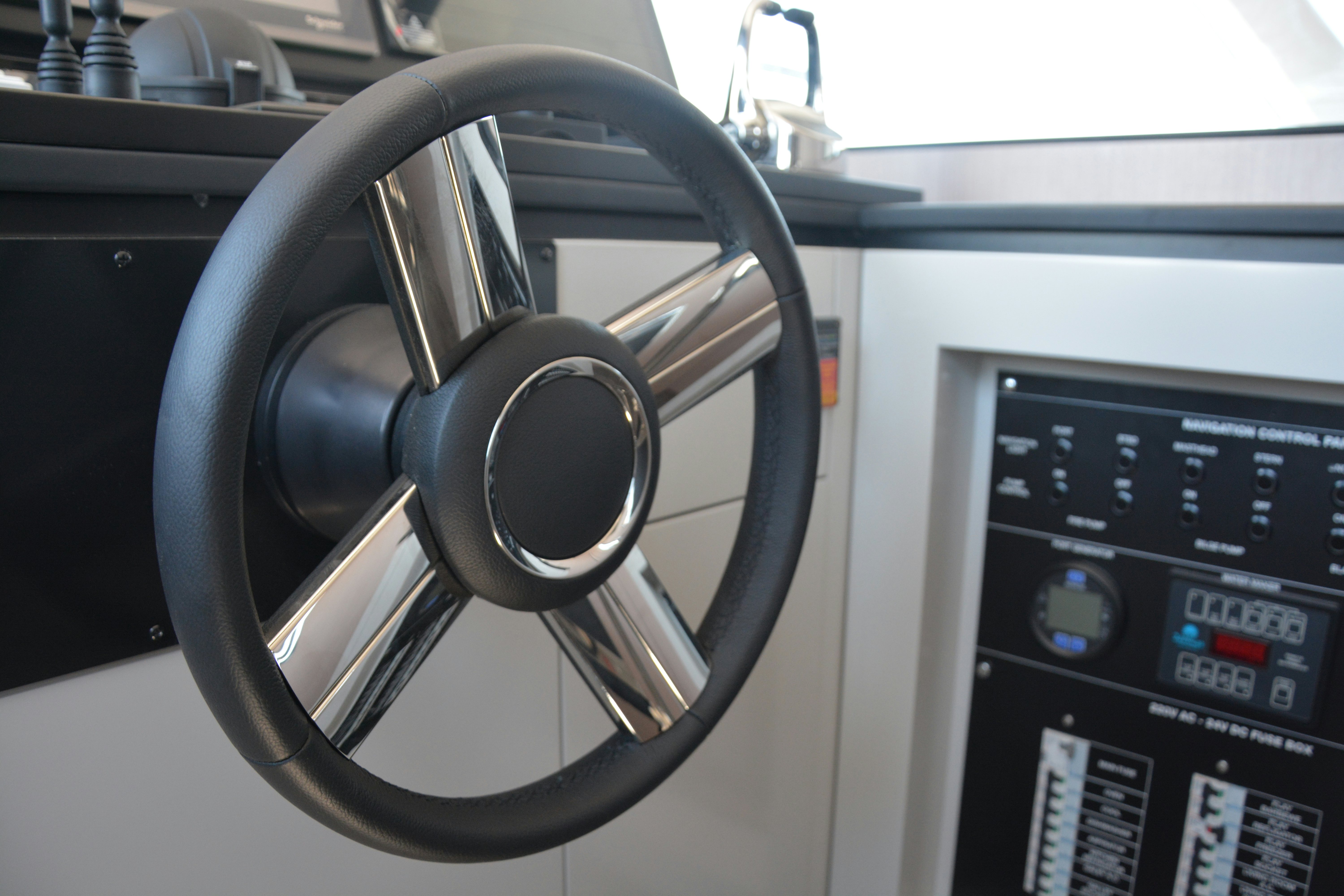 a steering wheel and dashboard of a car aboard ZIMA Yacht for Sale