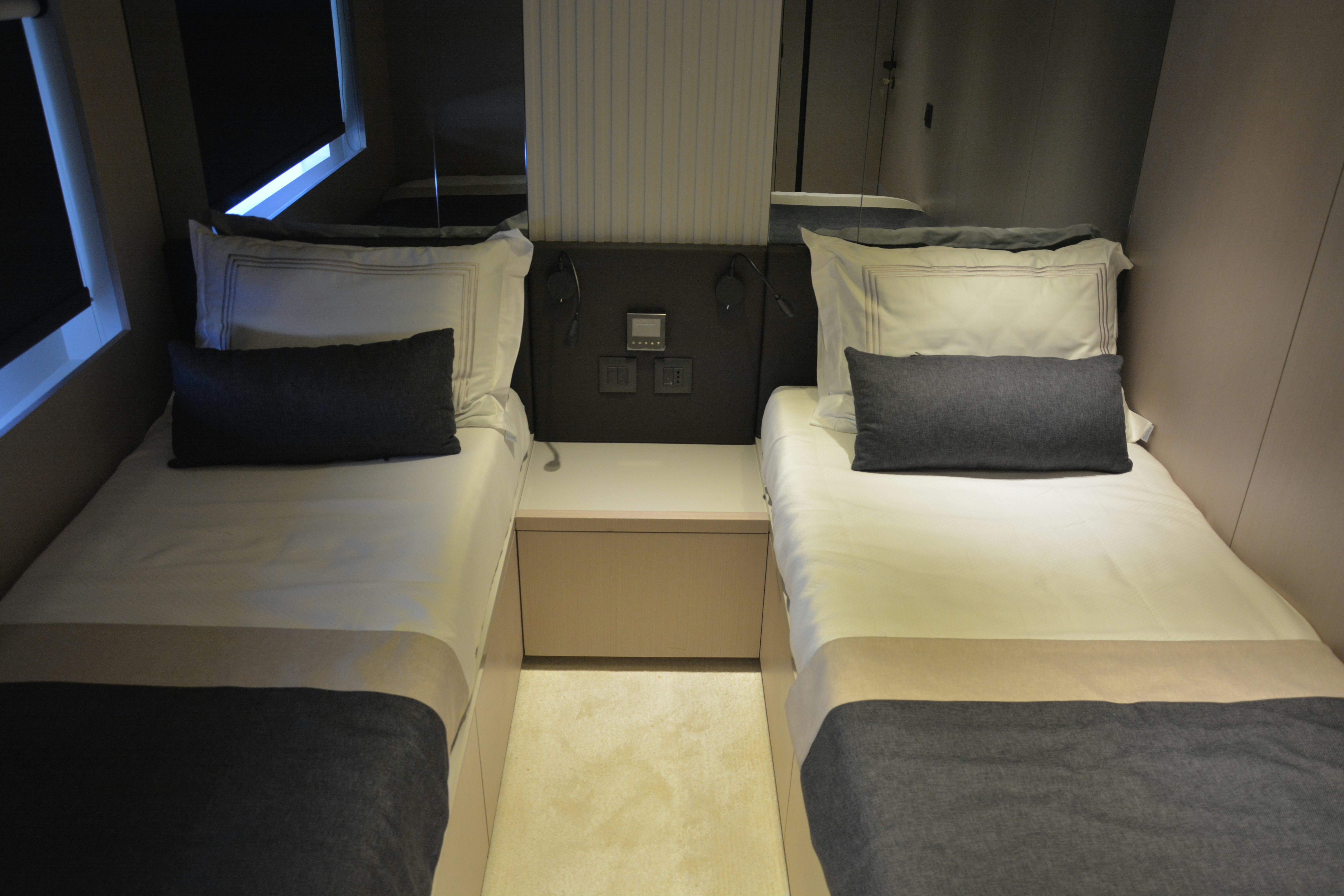 a room with beds and a tv aboard ZIMA Yacht for Sale