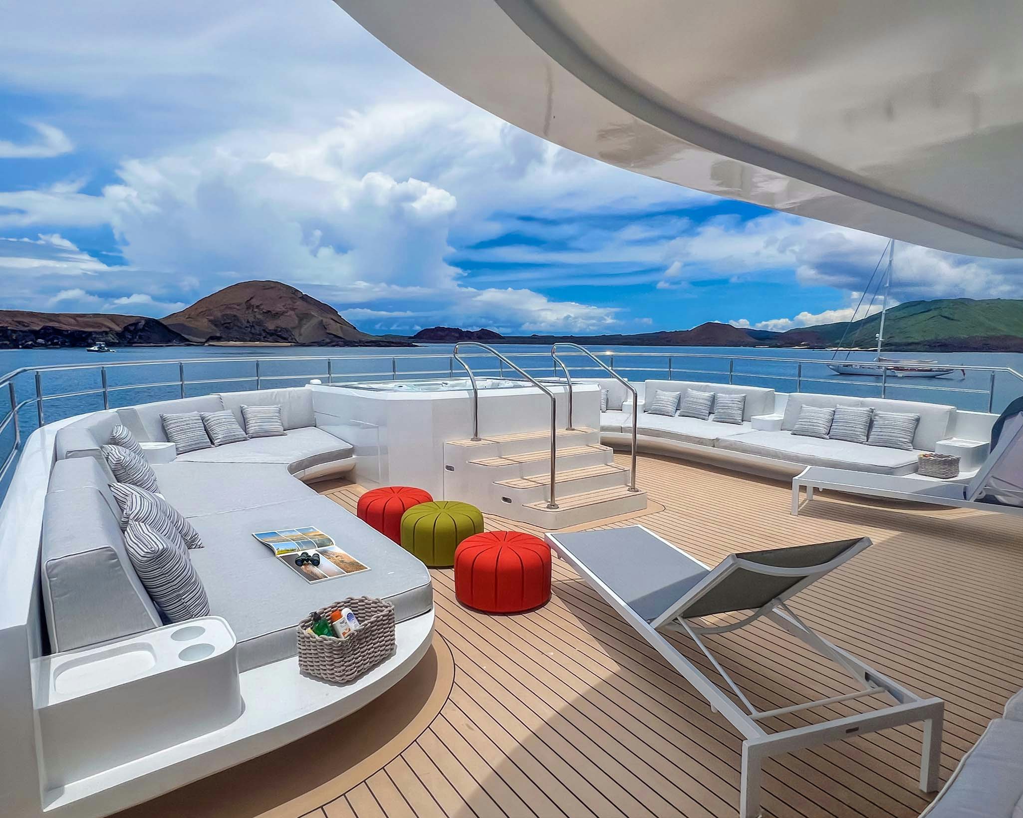 a deck with a view of the ocean and mountains aboard TRIBUTE - FREDDY'S LEGACY Yacht for Charter