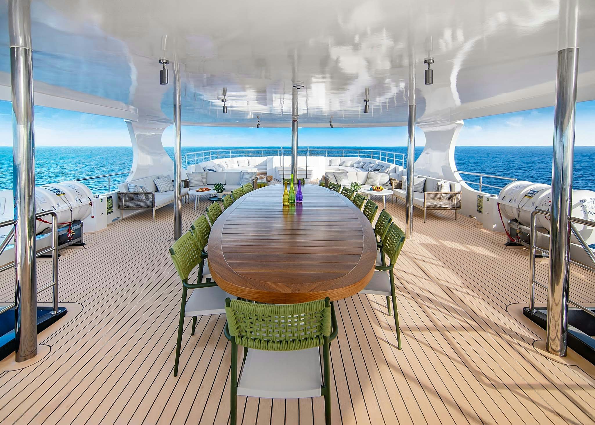 a deck with chairs and a table on it aboard TRIBUTE - FREDDY'S LEGACY Yacht for Charter