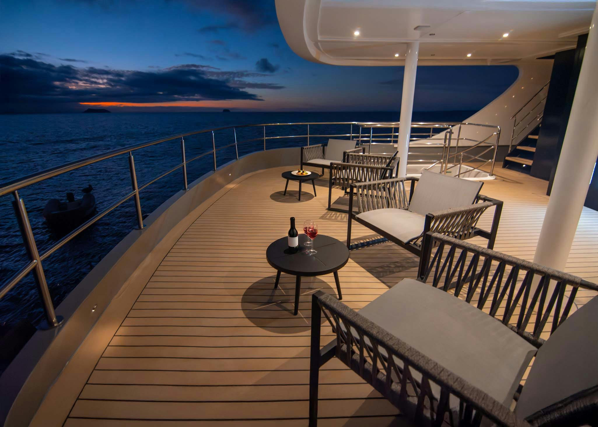 a deck with a view of the ocean and the sunset aboard TRIBUTE - FREDDY'S LEGACY Yacht for Charter