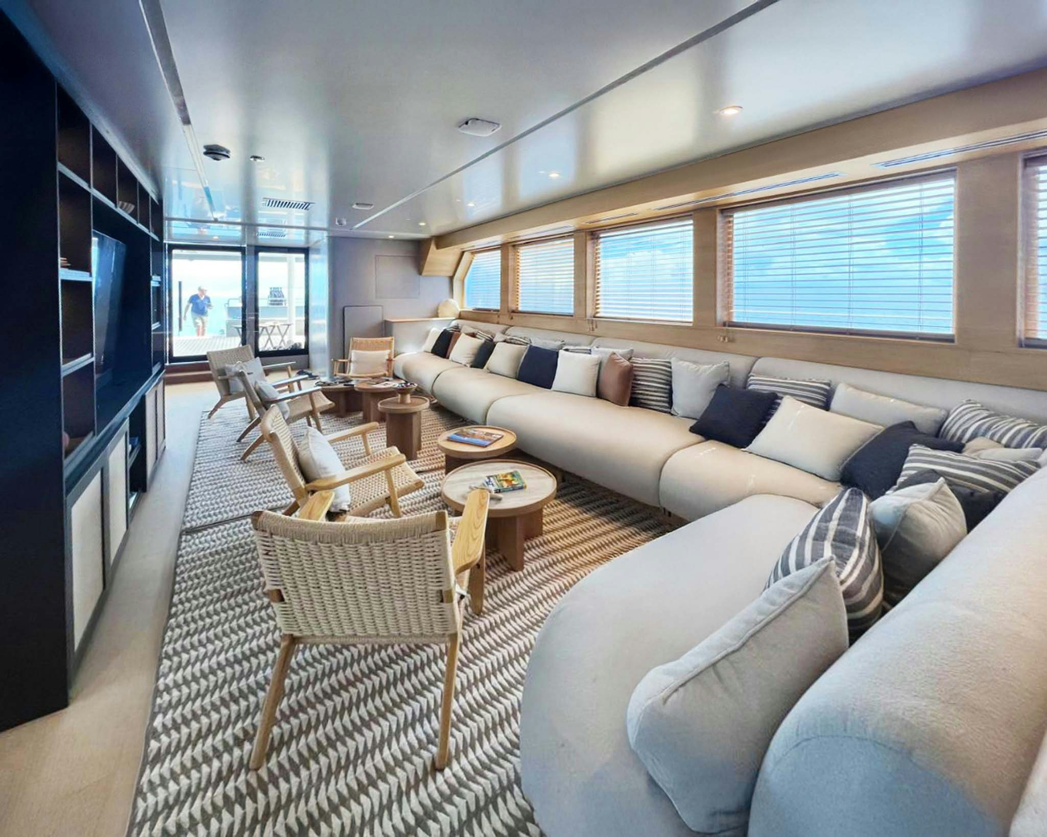 a living room with a couch and a tv aboard TRIBUTE - FREDDY'S LEGACY Yacht for Charter