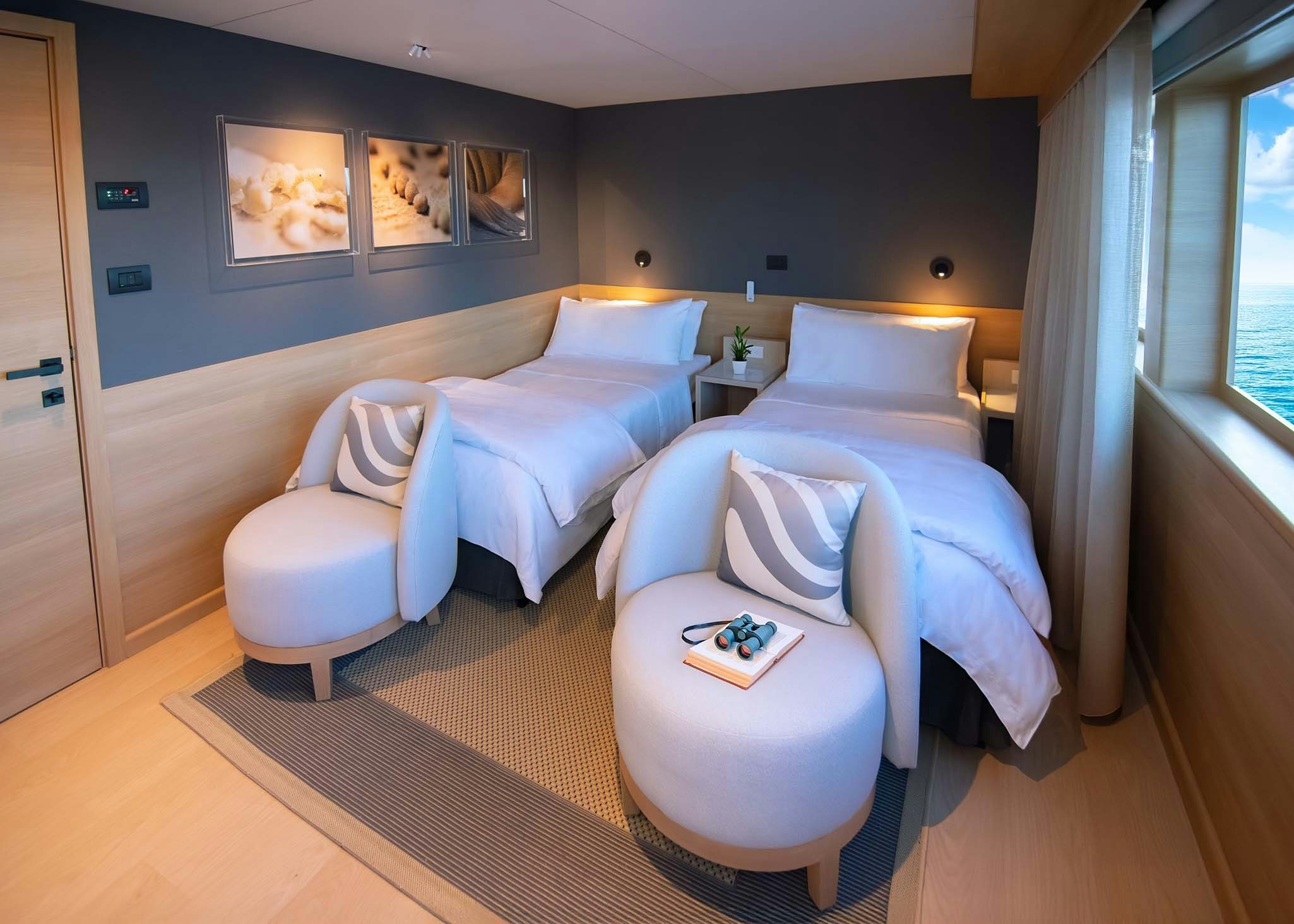 a room with a bed and a chair aboard TRIBUTE - FREDDY'S LEGACY Yacht for Charter