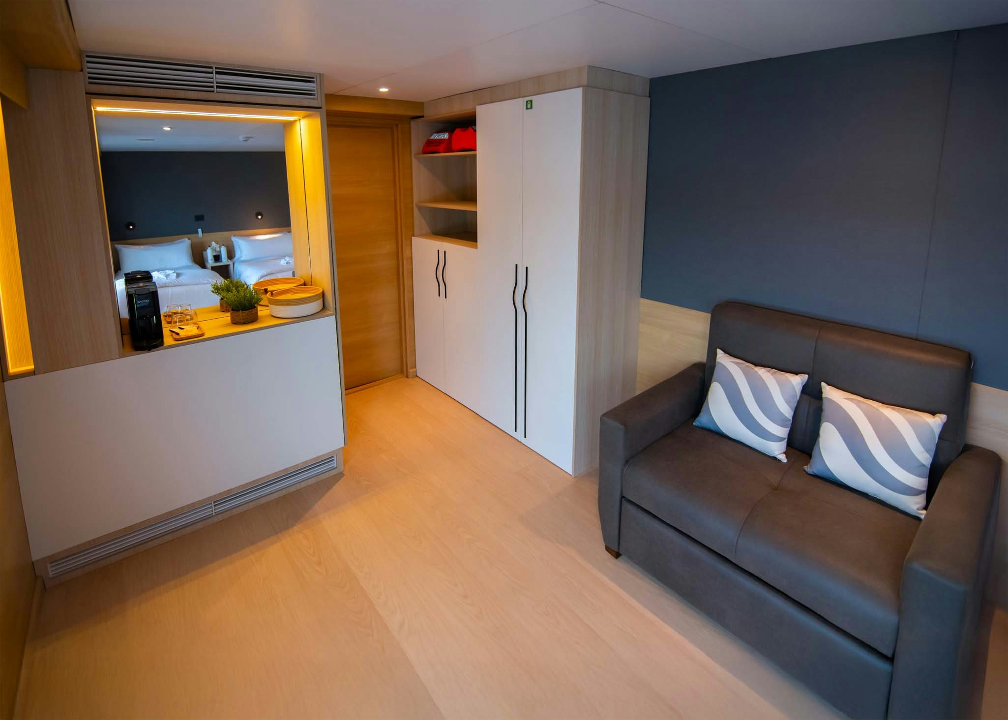 a living room with a couch and a kitchen aboard TRIBUTE - FREDDY'S LEGACY Yacht for Charter