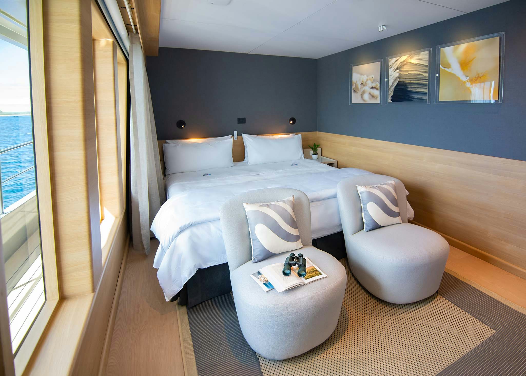 a bedroom with a bed and a chair aboard TRIBUTE - FREDDY'S LEGACY Yacht for Charter