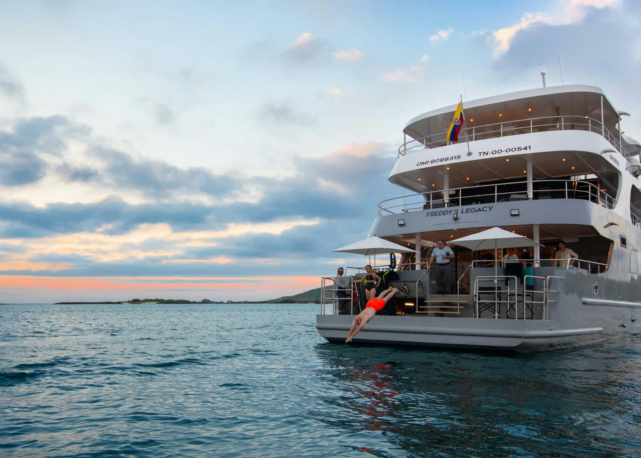 a large white boat with a flag on it aboard TRIBUTE - FREDDY'S LEGACY Yacht for Charter