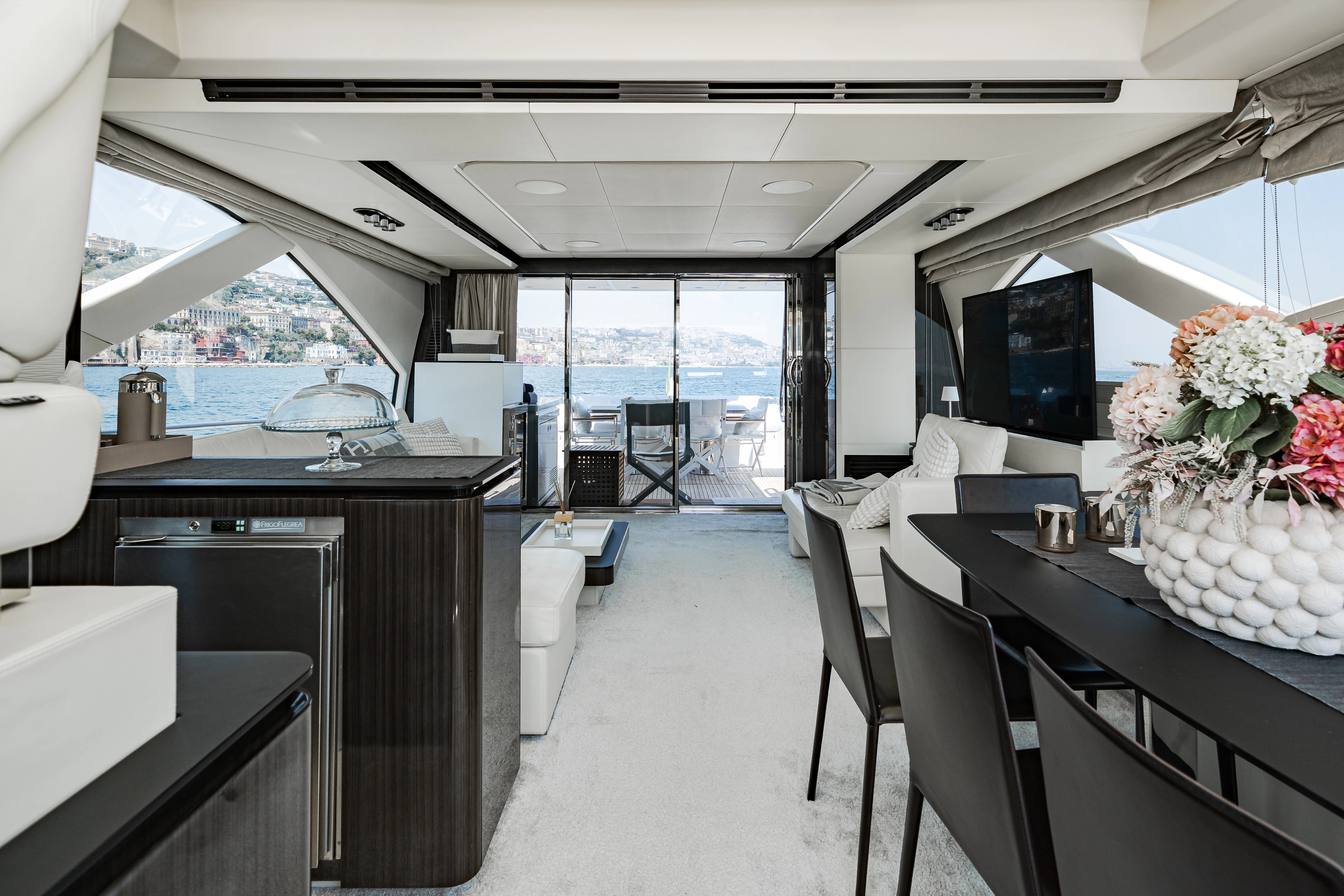 a room with a table chairs and a tv aboard JR 28 Yacht for Sale