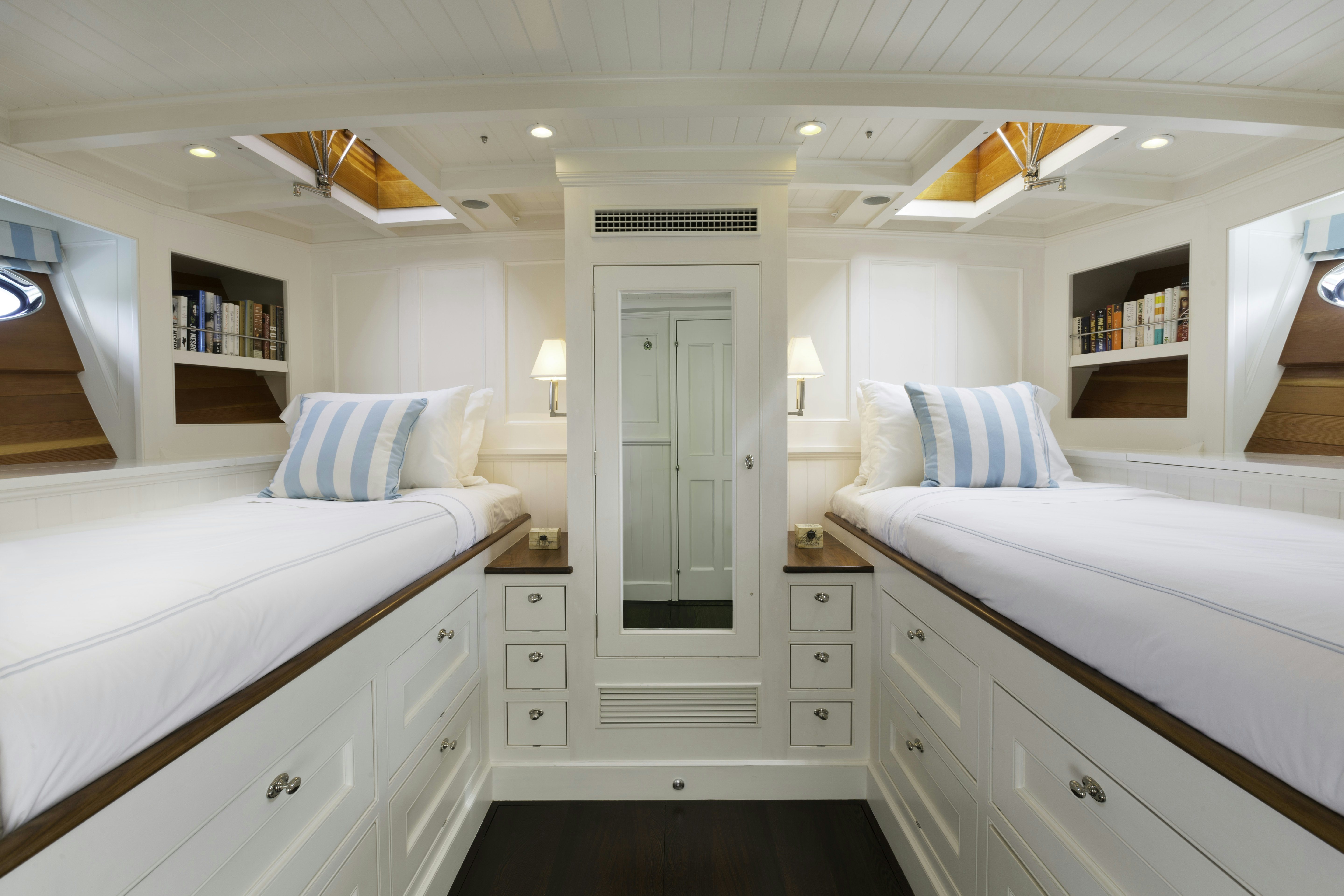 a room with white cabinets and a bed aboard BEQUIA Yacht for Sale