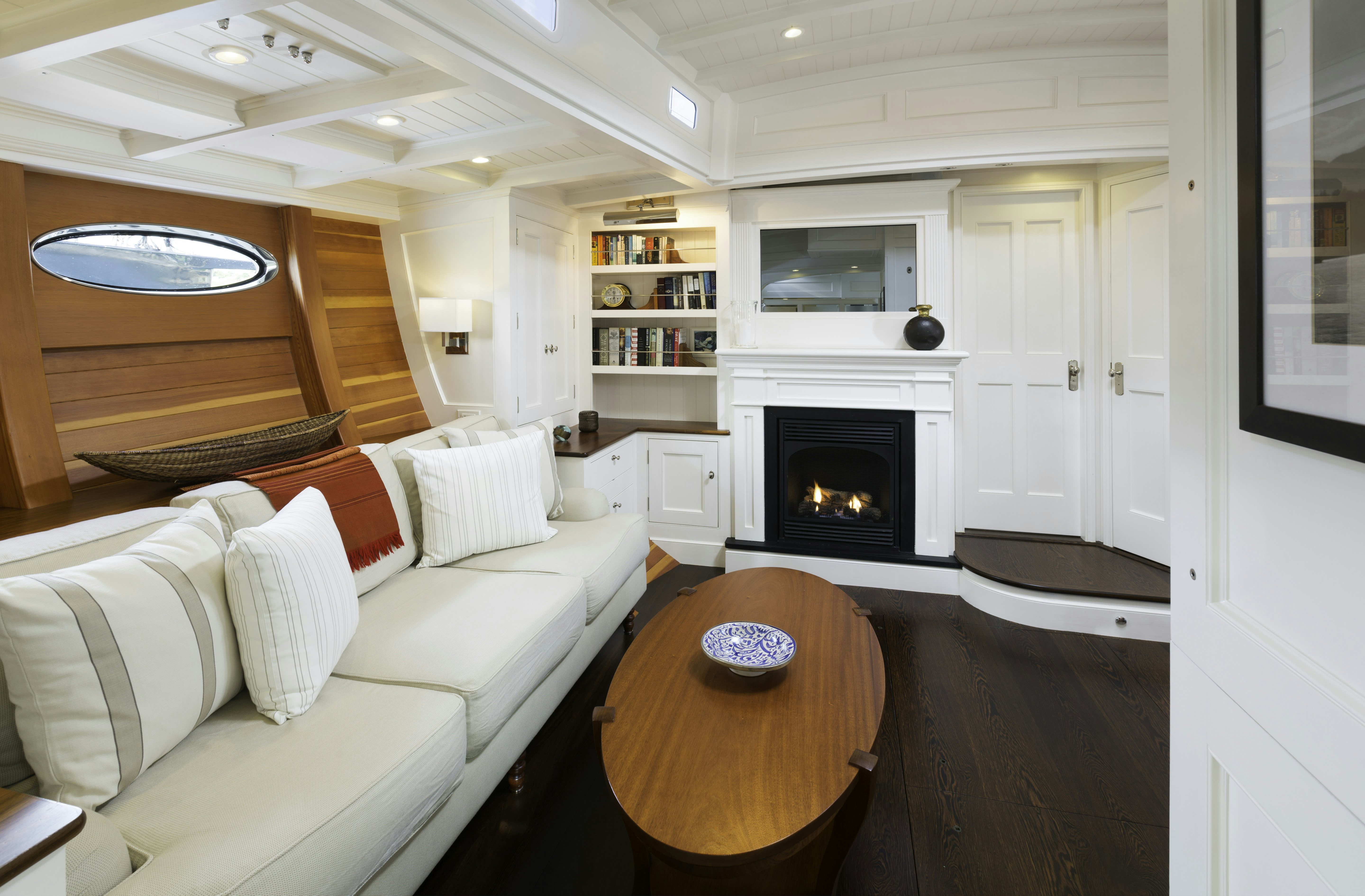 a living room with a fireplace aboard BEQUIA Yacht for Sale