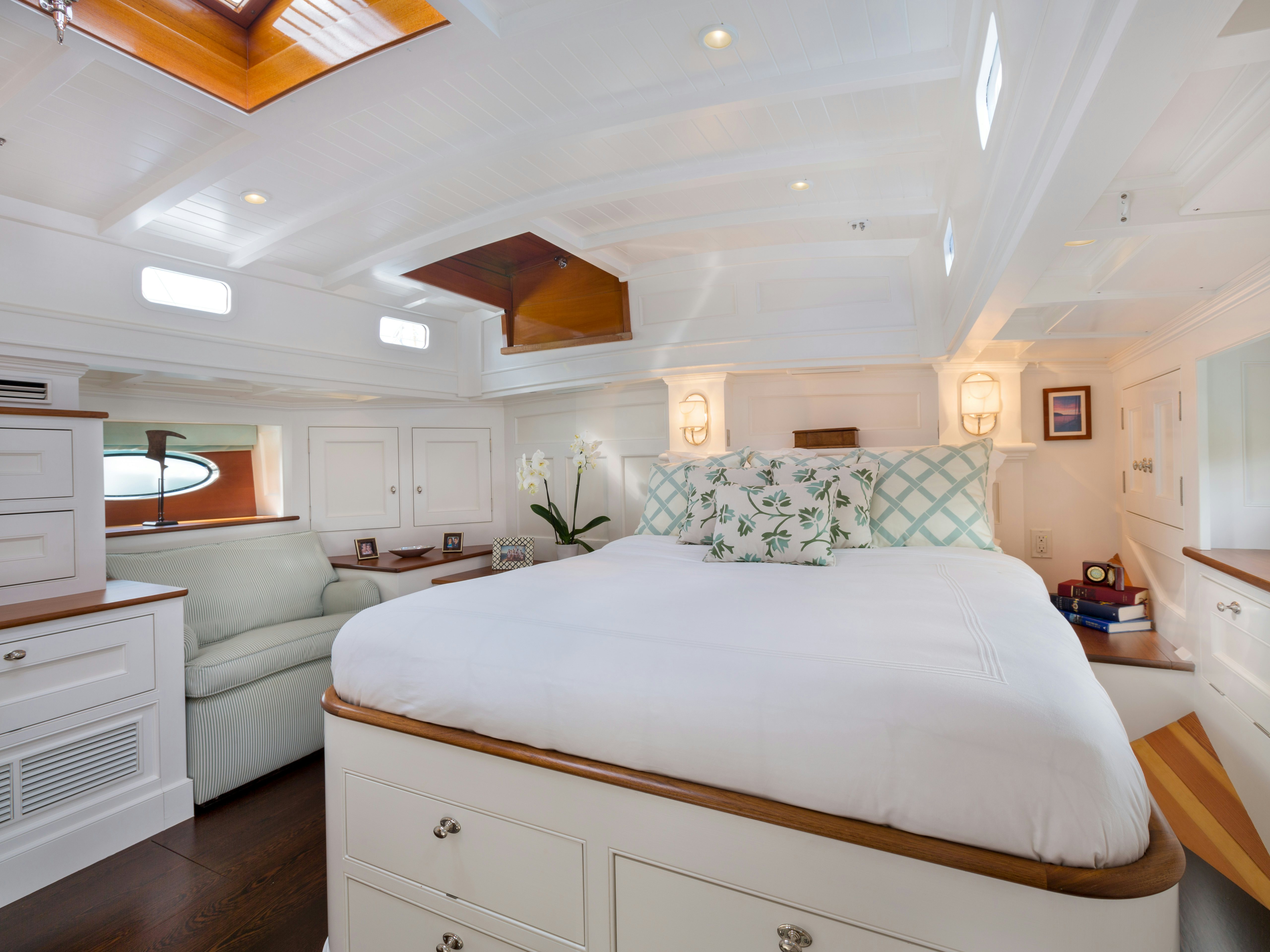 a bedroom with a bed and a couch aboard BEQUIA Yacht for Sale