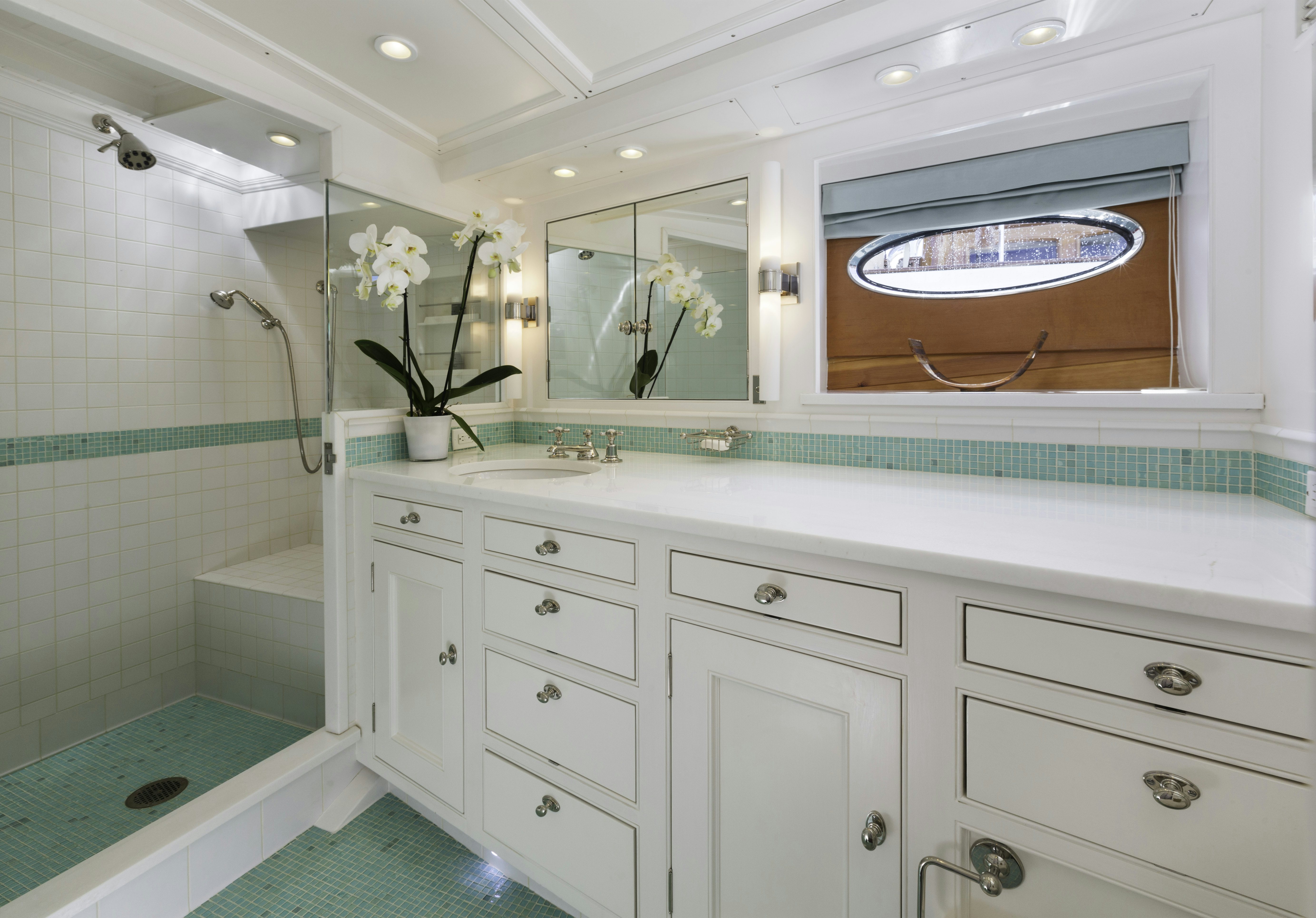 a bathroom with a glass shower aboard BEQUIA Yacht for Sale