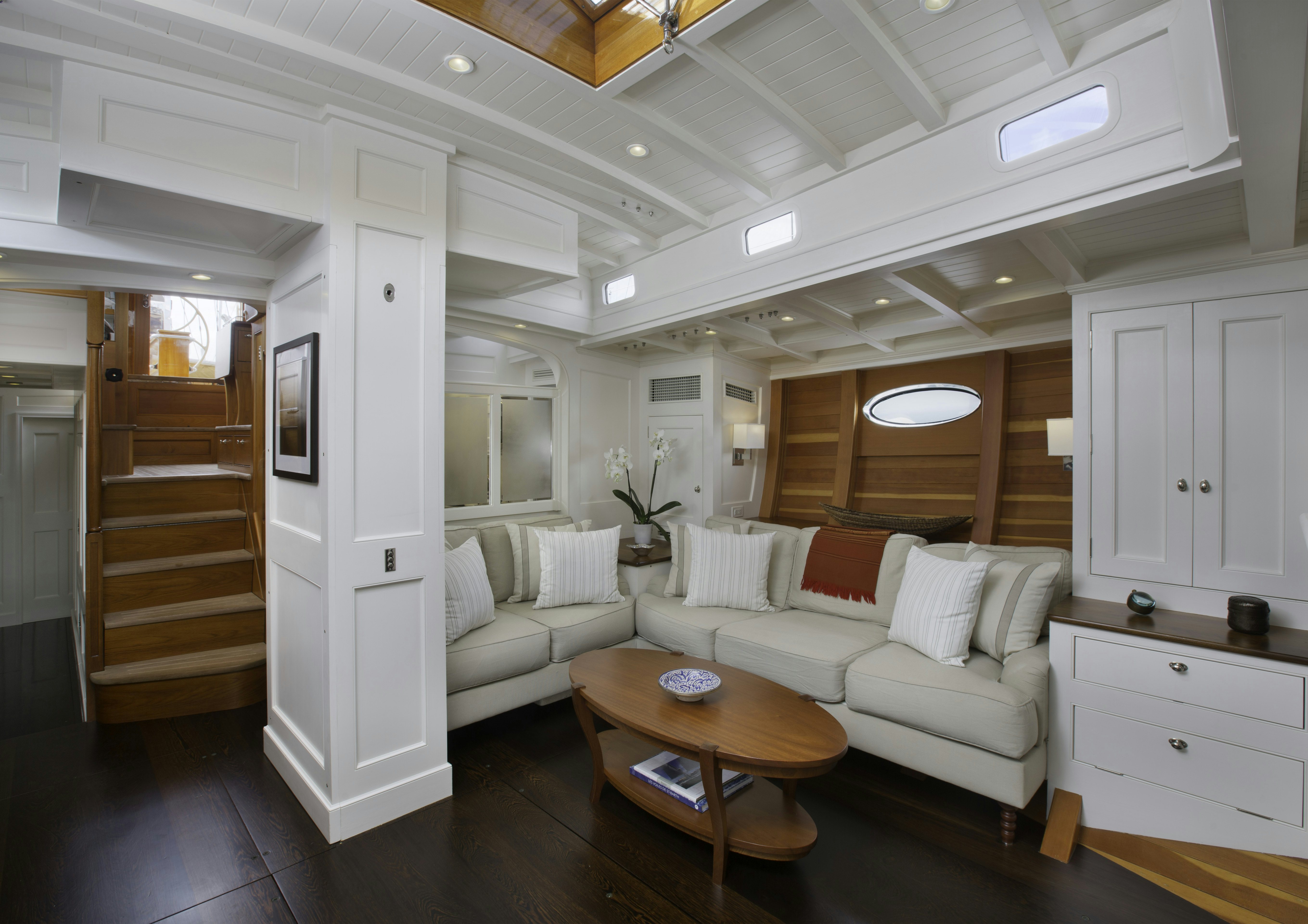 a living room with a staircase aboard BEQUIA Yacht for Sale
