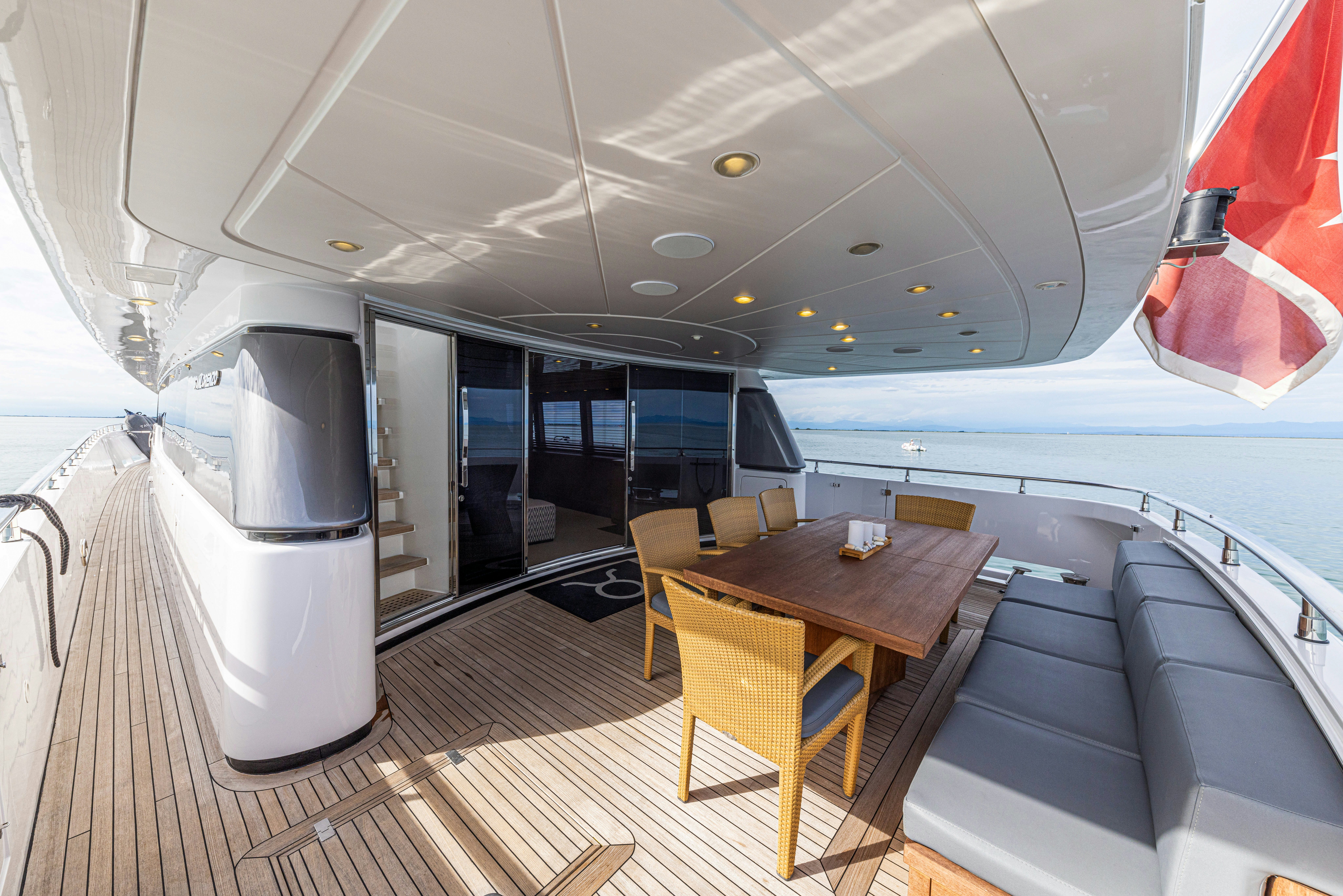 a room with a table and chairs aboard TAURO Yacht for Sale