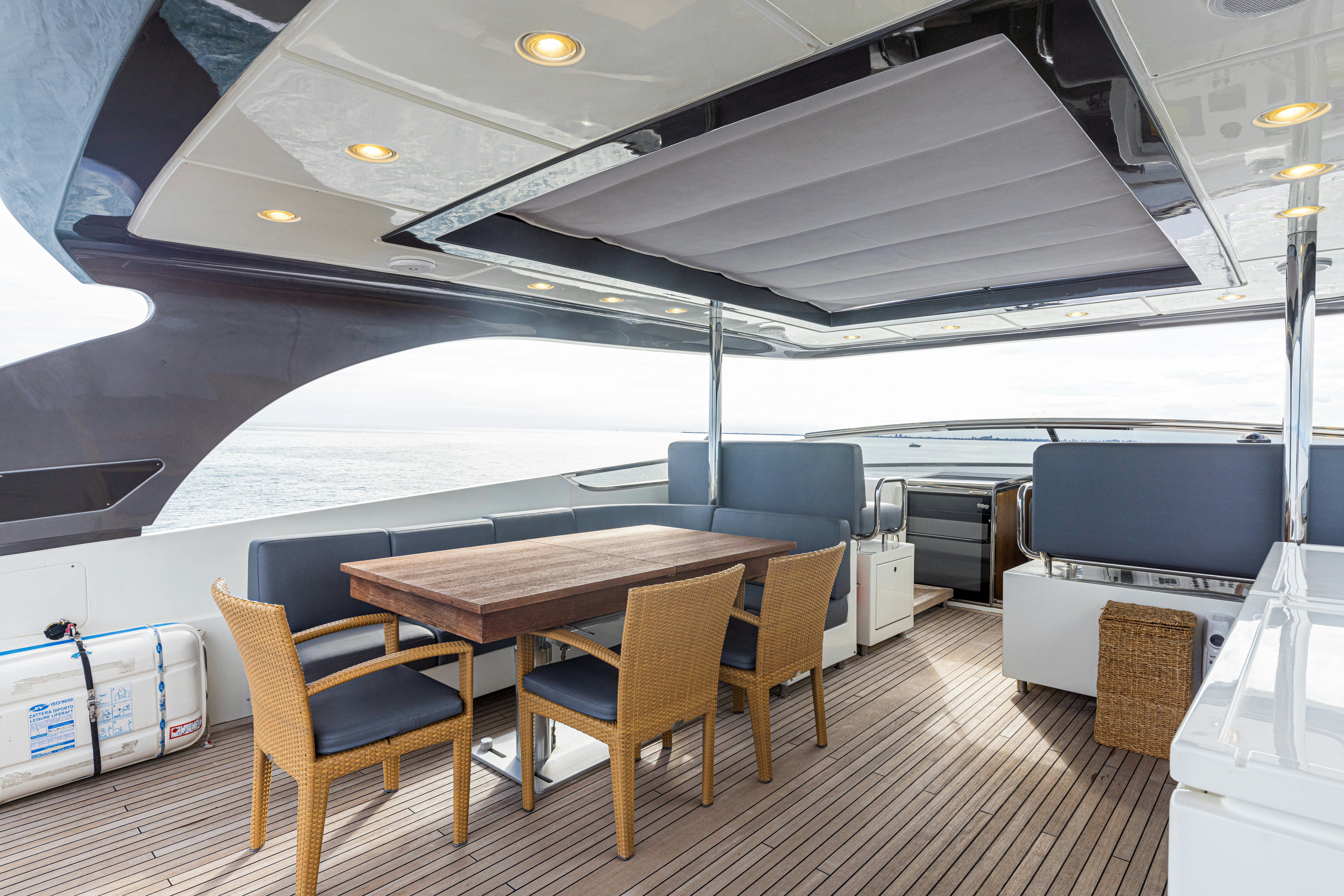 a table and chairs on a deck aboard TAURO Yacht for Sale