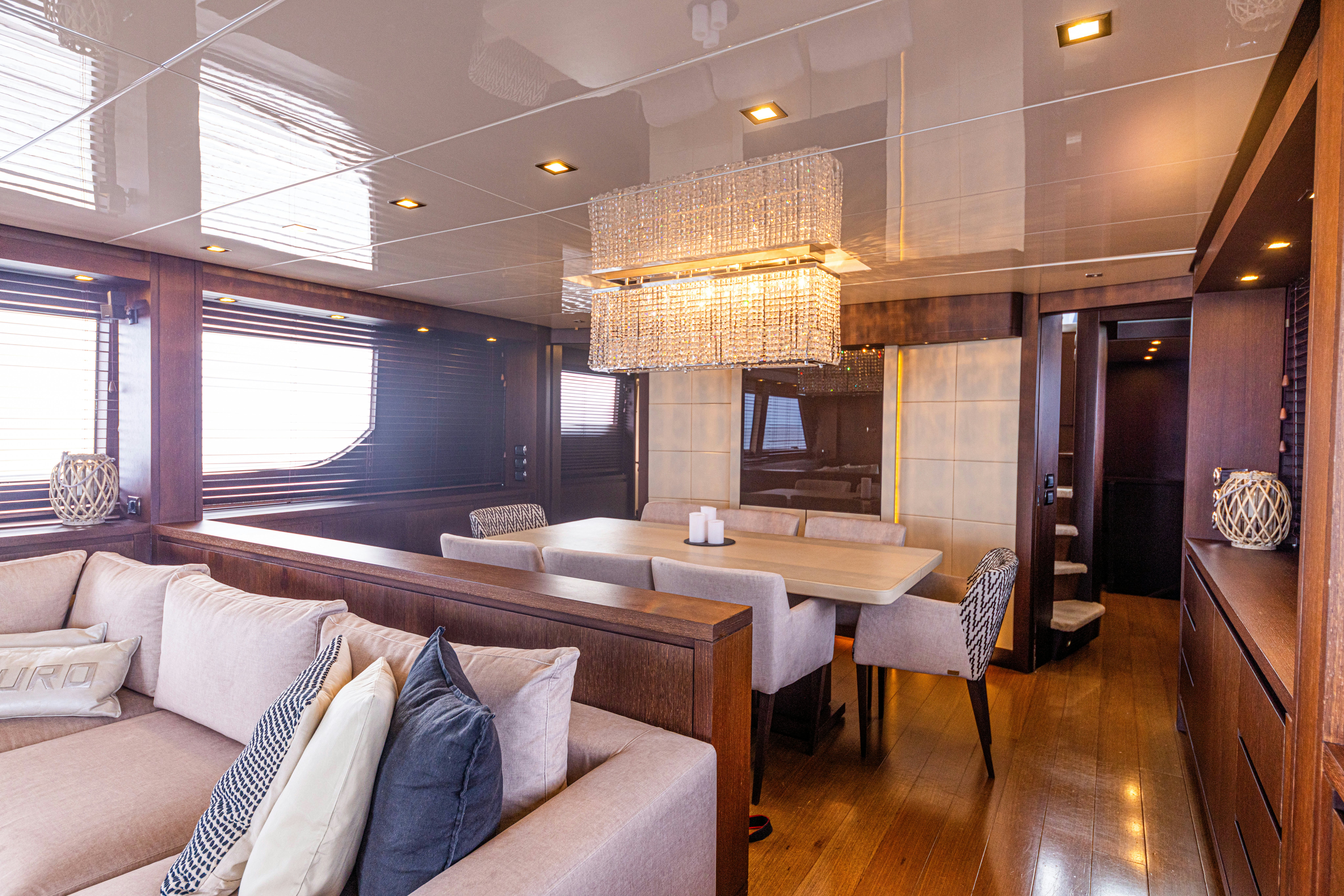 a large living room with a large table and chairs aboard TAURO Yacht for Sale