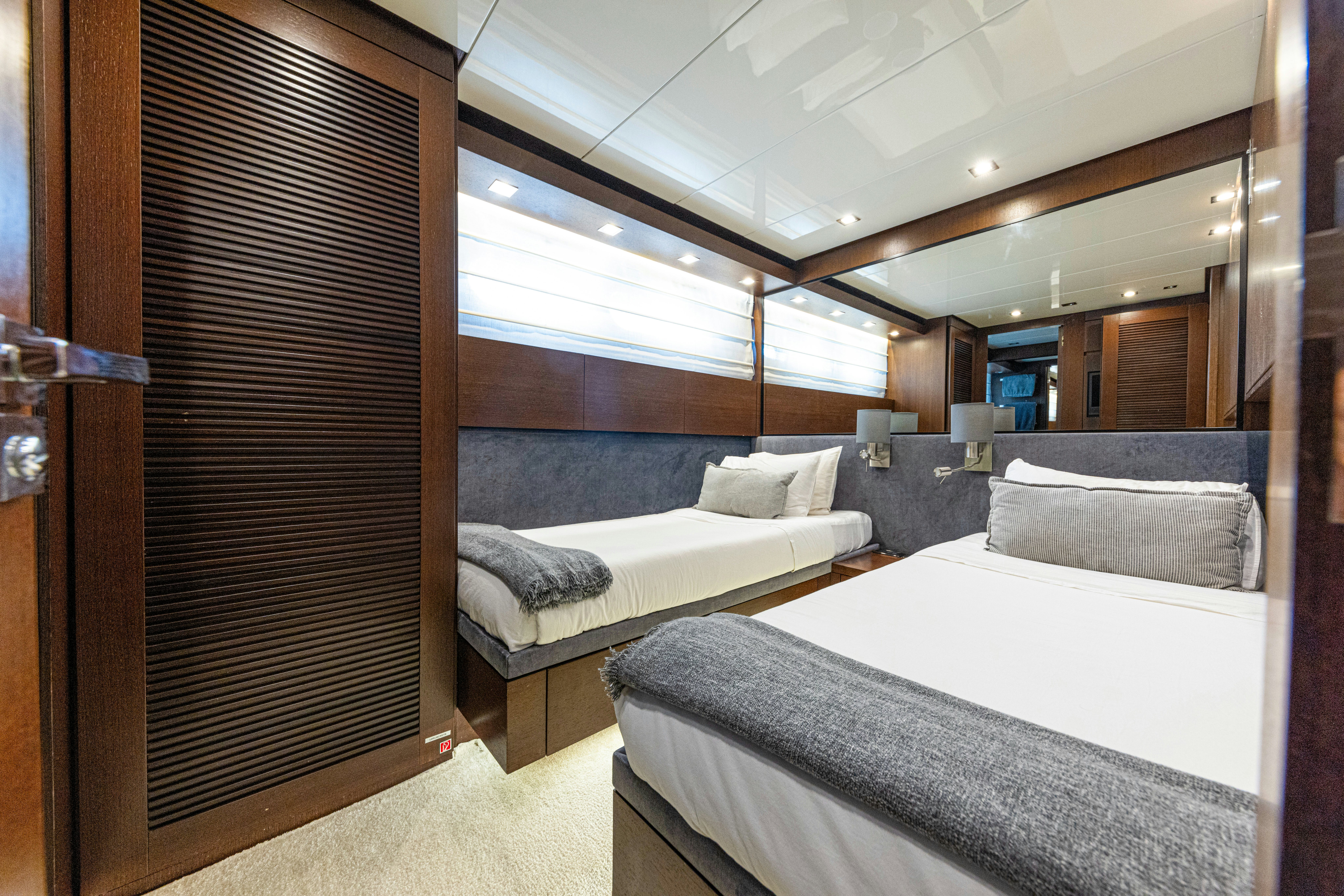 a room with a bed and a couch aboard TAURO Yacht for Sale