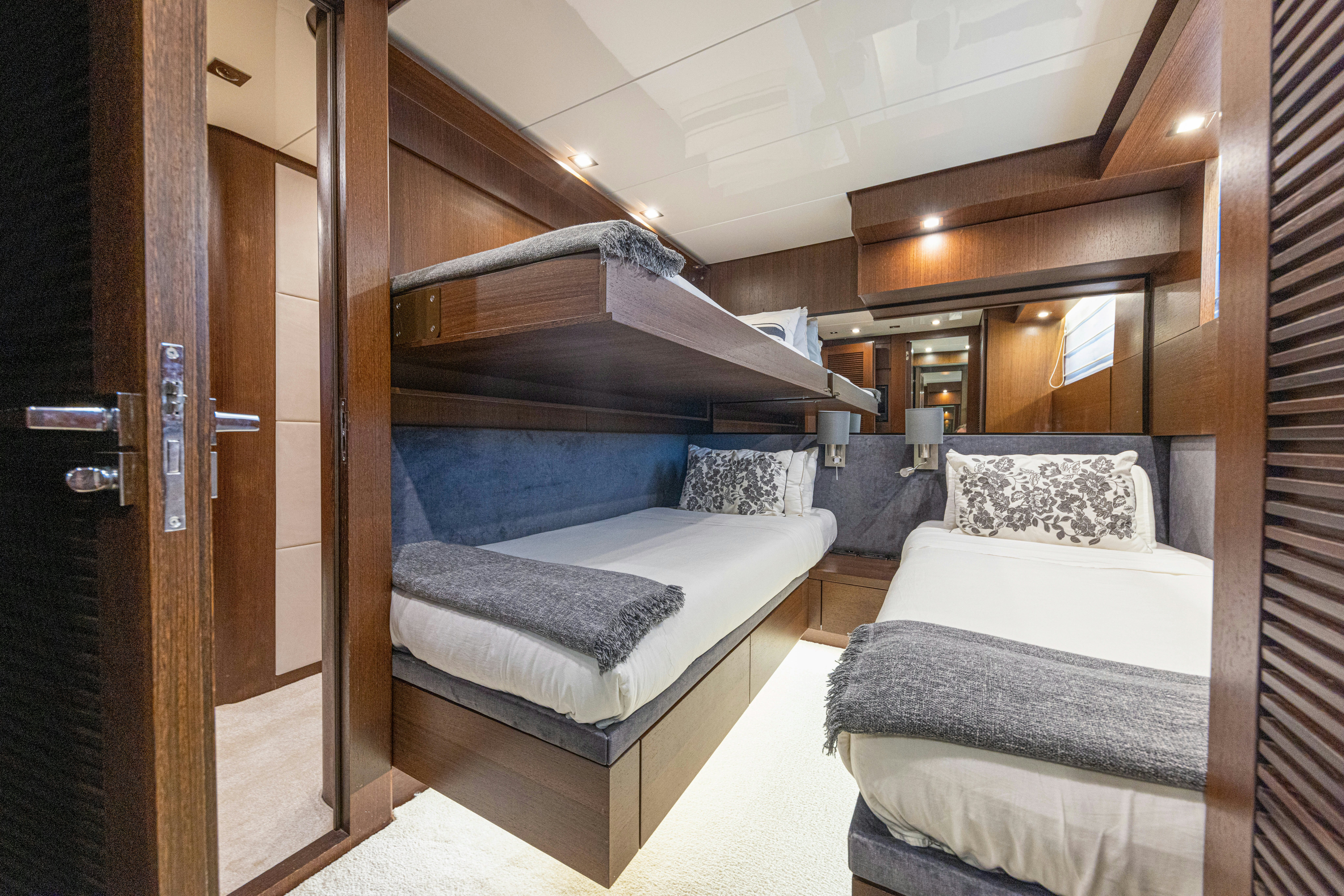 a room with a bed and a wood door aboard TAURO Yacht for Sale