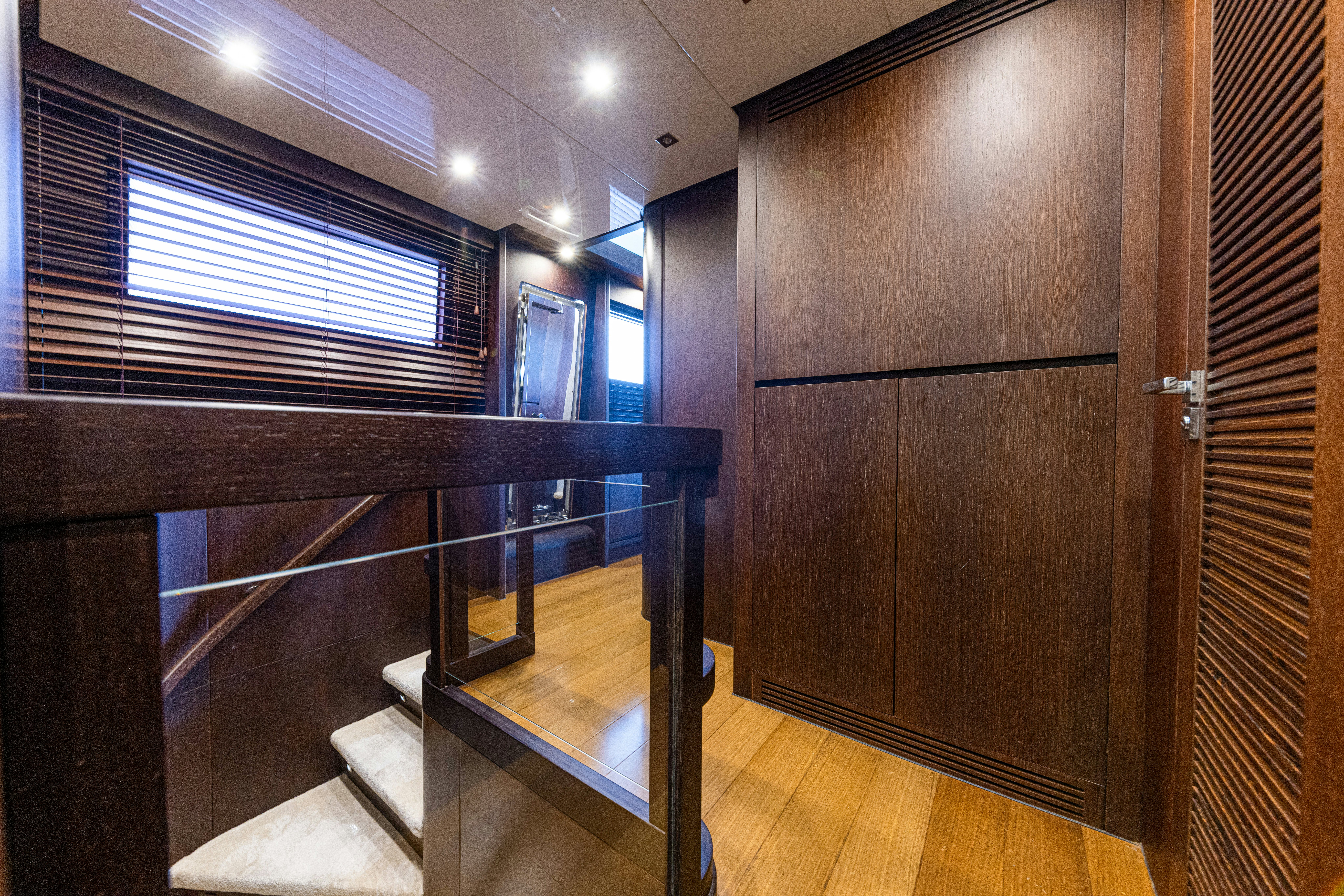 a room with wooden cabinets aboard TAURO Yacht for Sale