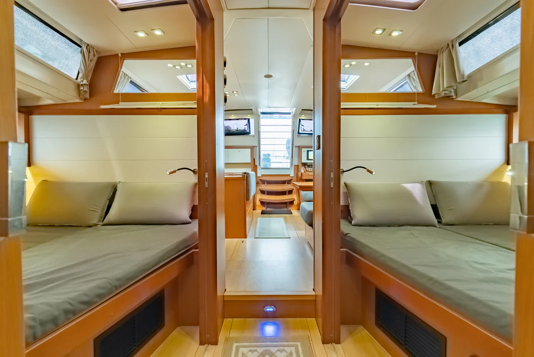 a room with a bed and a table aboard IMPERIA Yacht for Sale