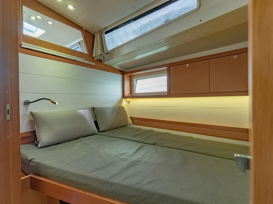 a bed with a blue sheet aboard IMPERIA Yacht for Sale