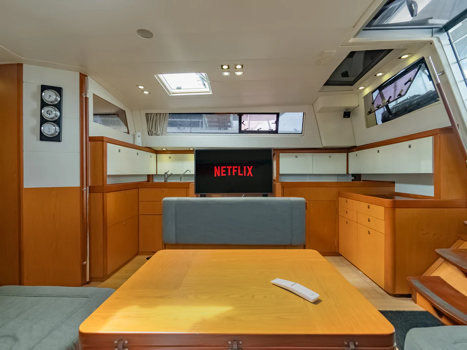 a room with a table and tv aboard IMPERIA Yacht for Sale
