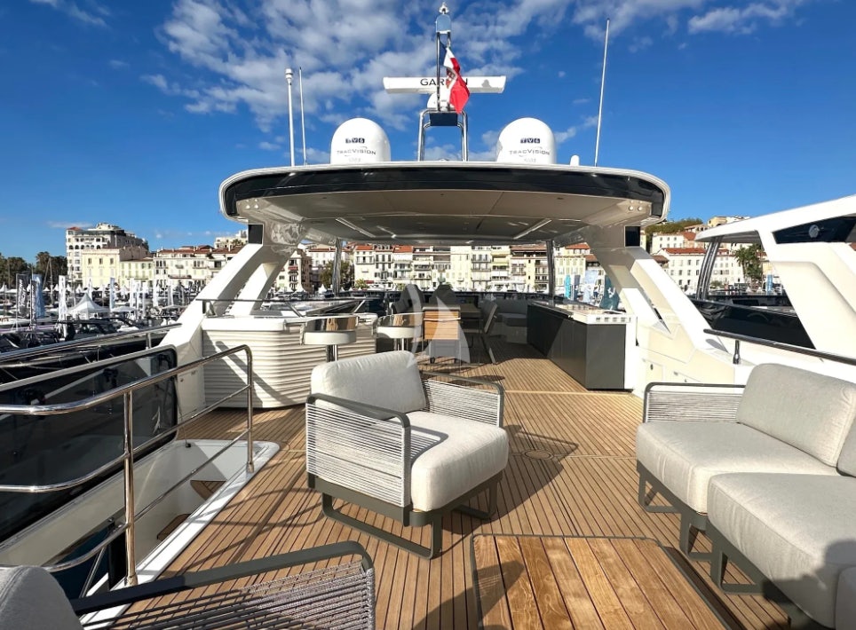a deck with a boat and chairs on it aboard SEMELA Yacht for Charter