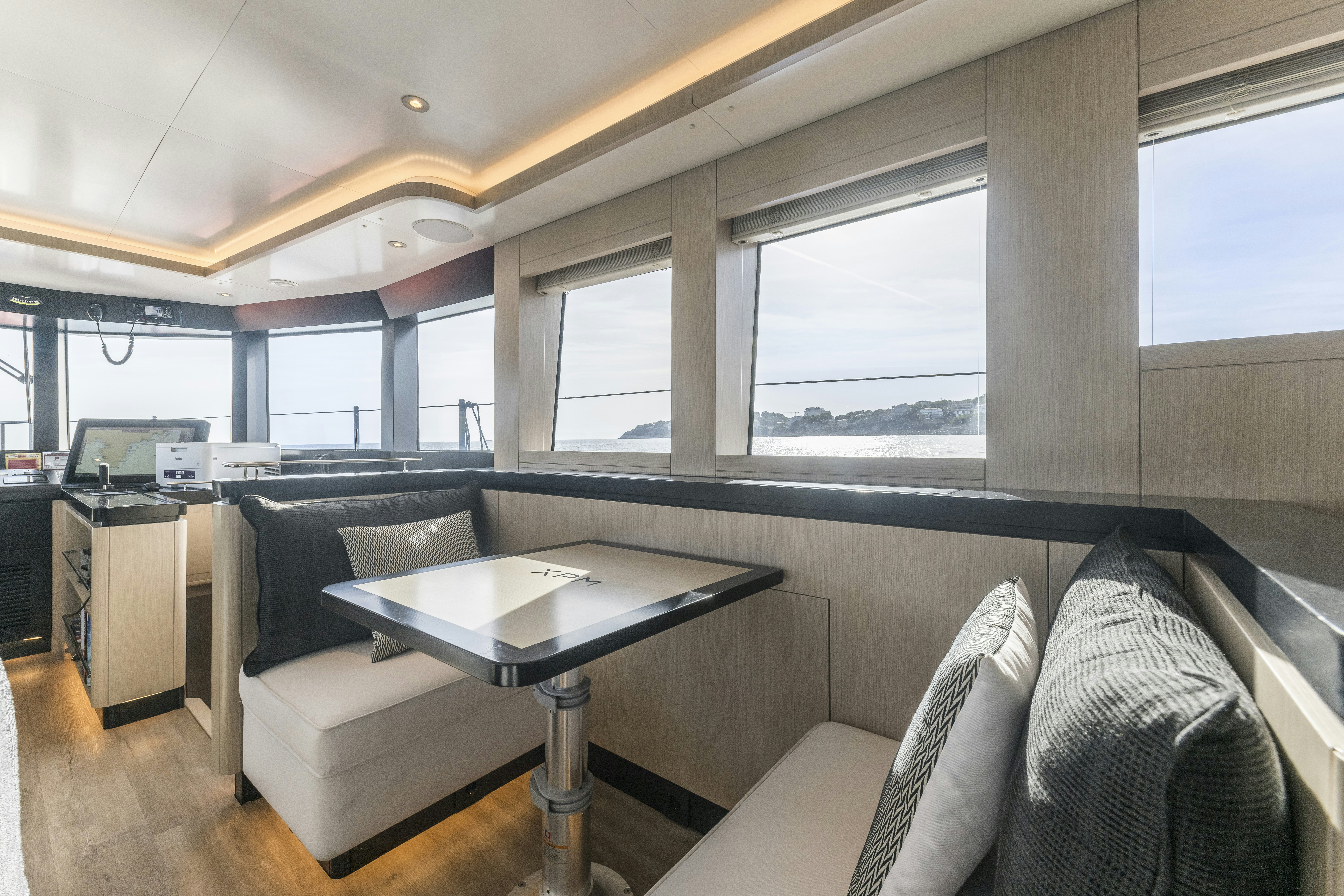 a room with a couch and a table aboard VANGUARD Yacht for Sale