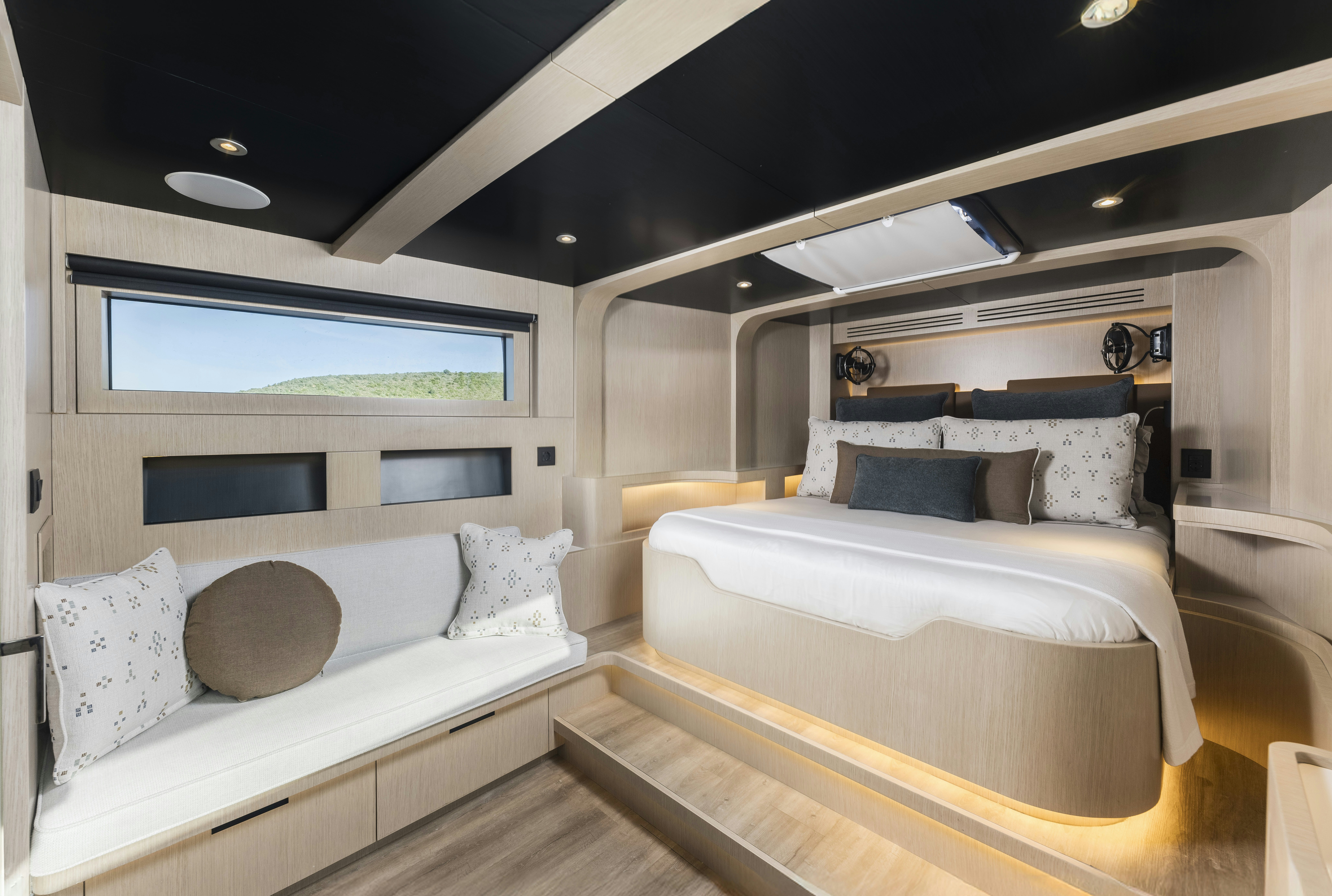 a room with a bed and a couch aboard VANGUARD Yacht for Sale