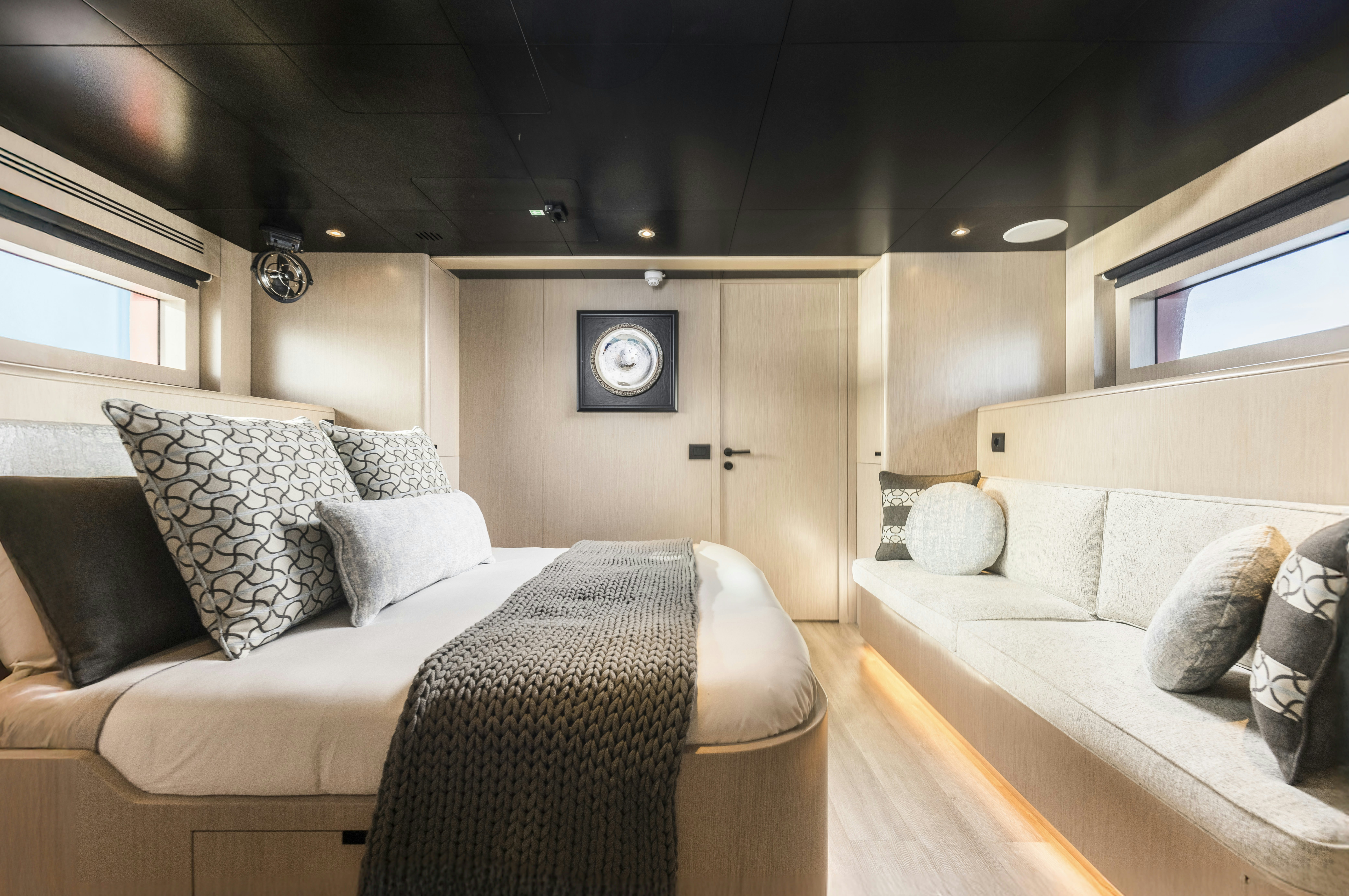 a room with a bed and a couch aboard VANGUARD Yacht for Sale