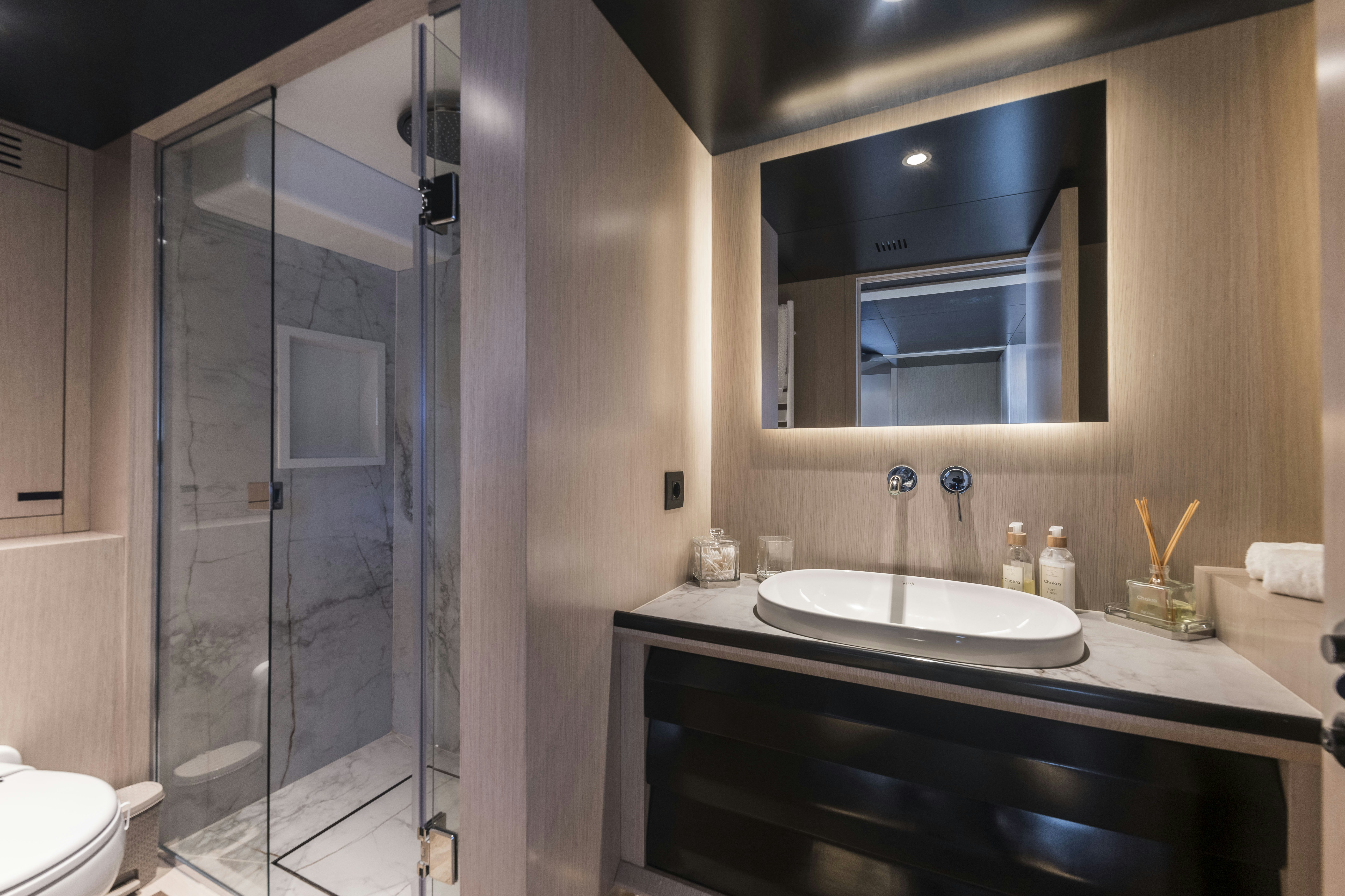 a bathroom with a glass shower aboard VANGUARD Yacht for Sale