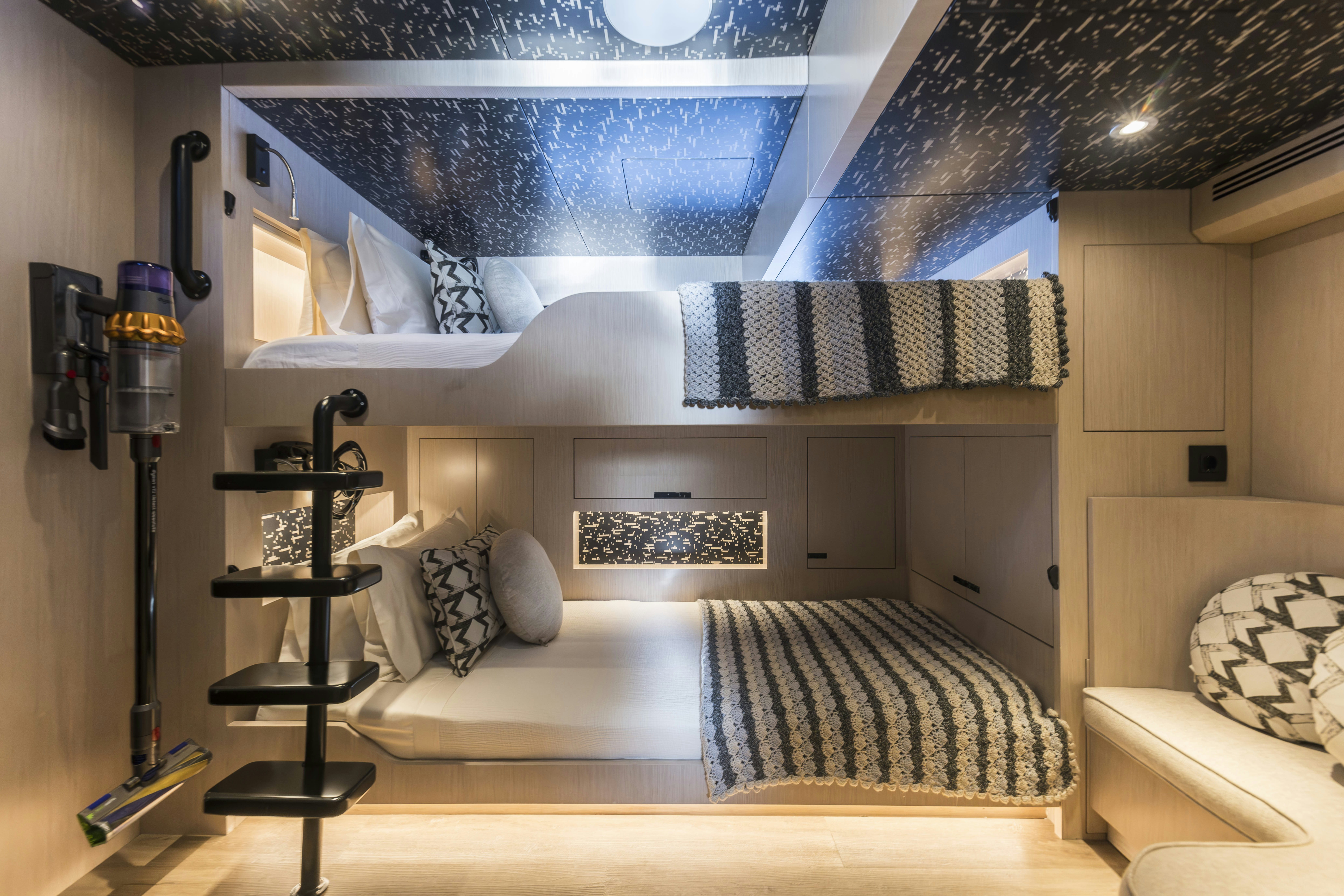 a bedroom with a bed and a desk aboard VANGUARD Yacht for Sale