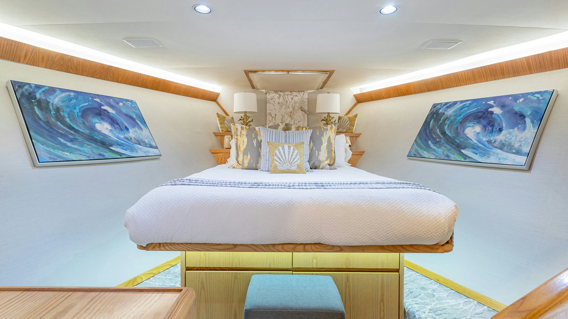 a bedroom with a bed and a painting on the wall aboard MARGATE Yacht for Sale
