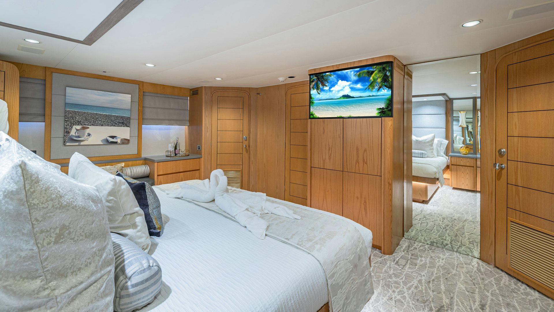 a bedroom with a bed and a television aboard MARGATE Yacht for Sale