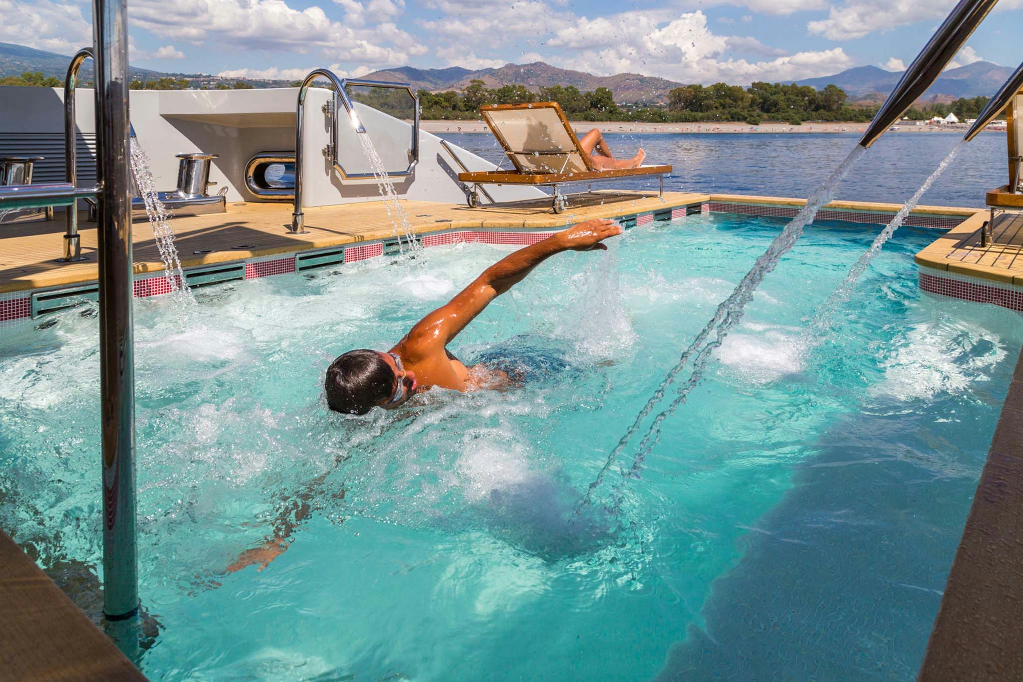 a person swimming in a pool aboard AXIOMA Yacht for Charter