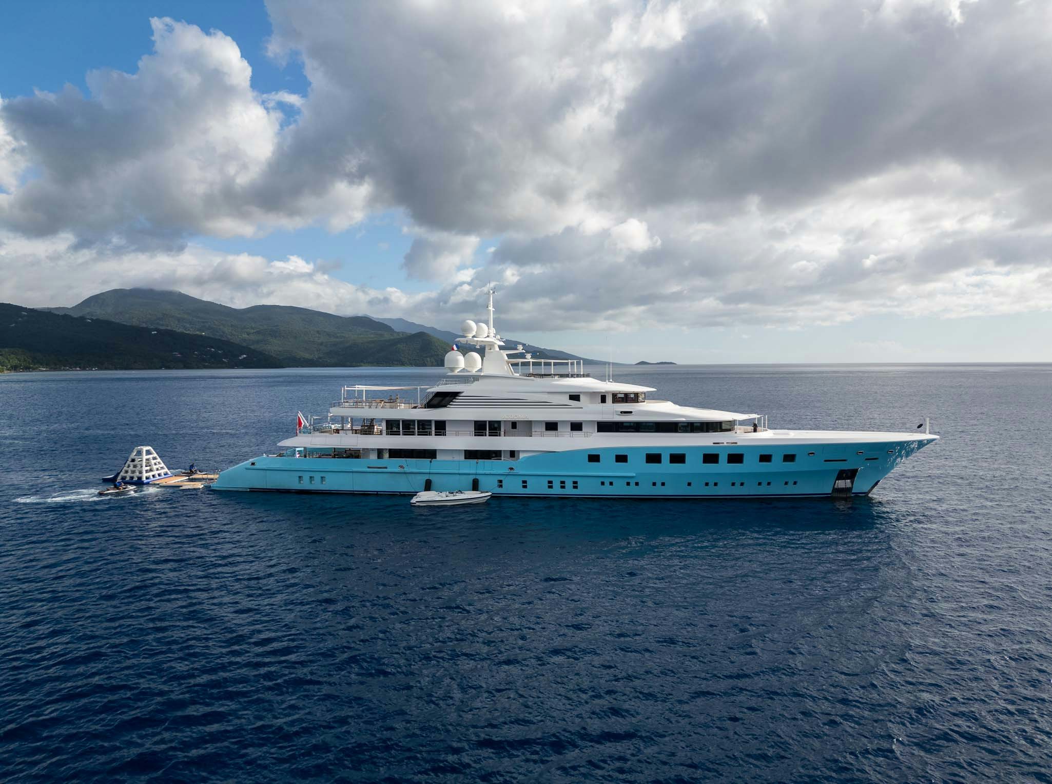 a large white boat in the water aboard AXIOMA Yacht for Charter