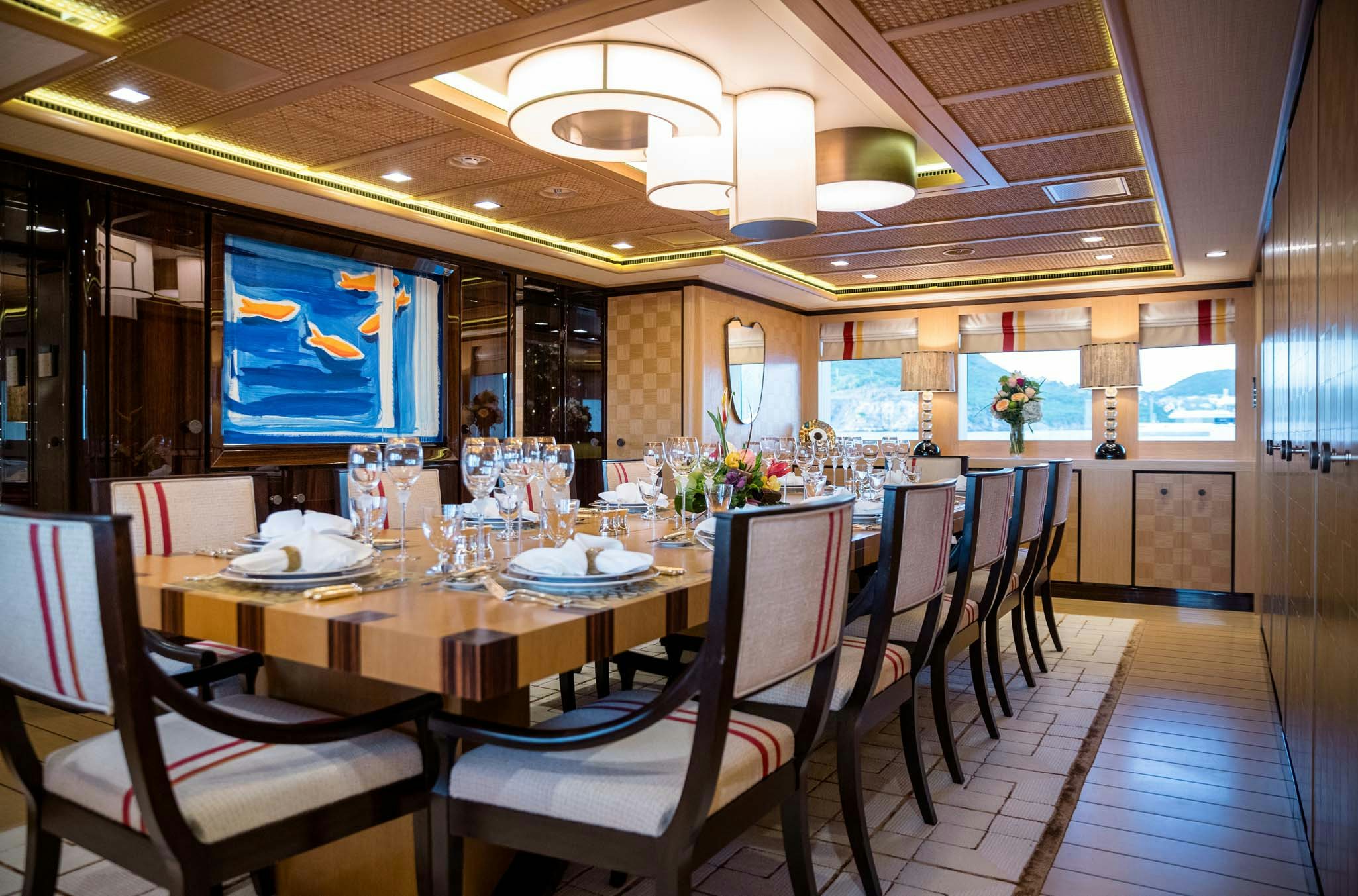 a room with a table chairs and a tv aboard AXIOMA Yacht for Charter