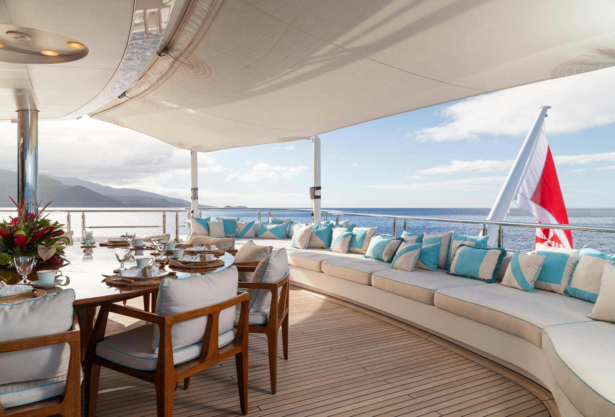 a patio with a table and chairs aboard AXIOMA Yacht for Charter